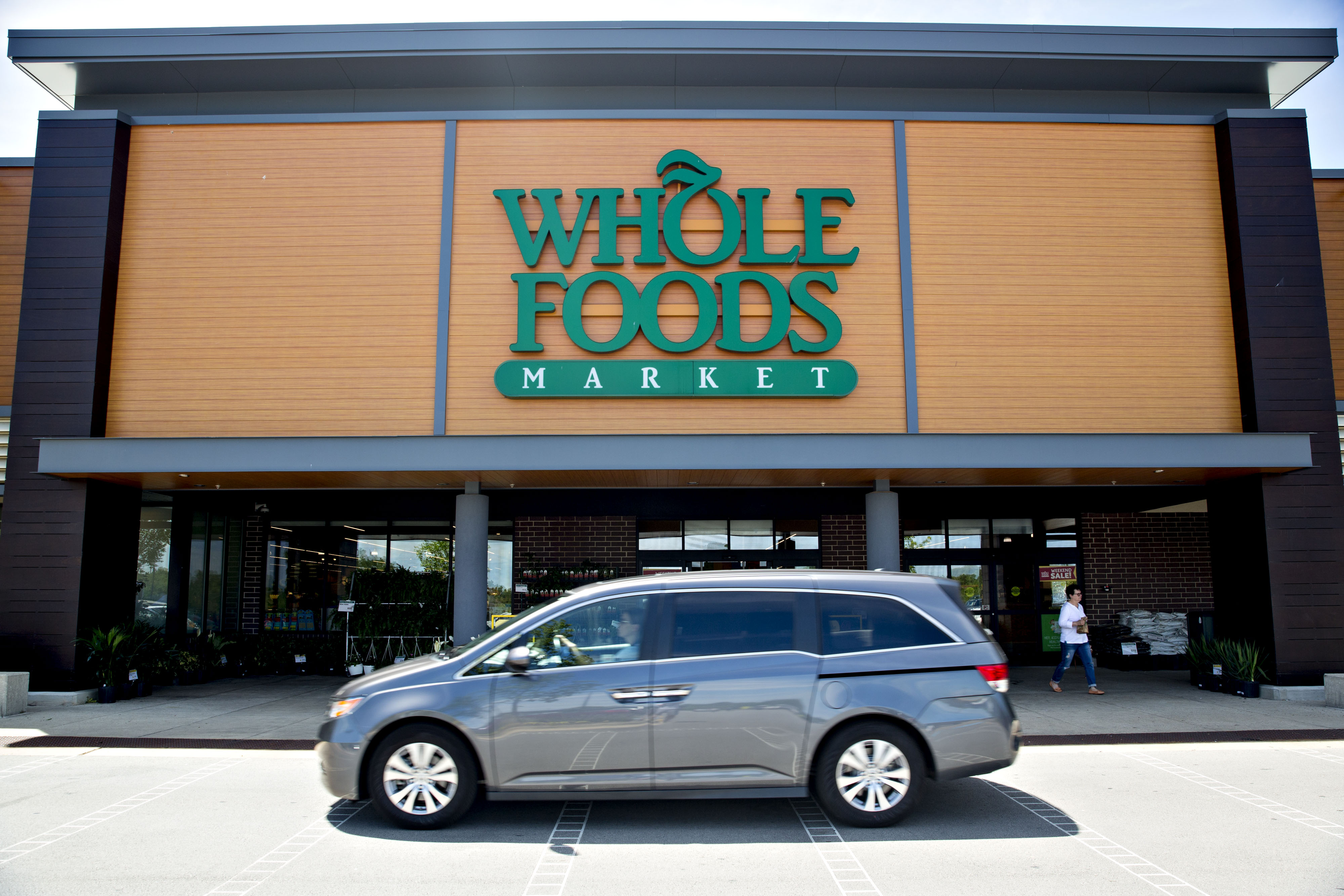 A vehicle passes in front of a Whole Foods Market Inc. location in Willowbrook, Illinois, U.S., on Friday, June 16, 2017. (Daniel Acker—Bloomberg via Getty Images)