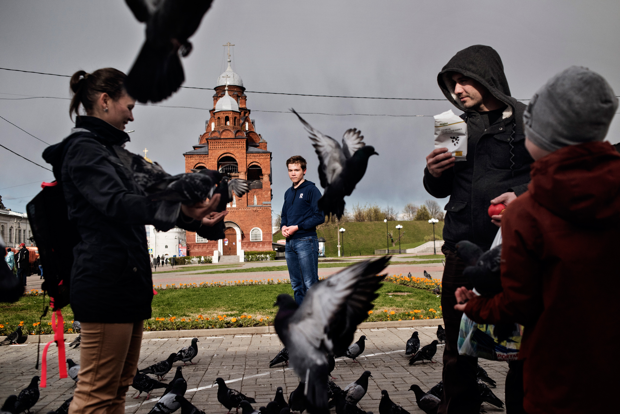 Vladimir Russia May 12 2017 Mikhail Ogorodnikov, 16, looks at a family feeds pigeons in downtown Vladimir. He said he'd plan to join new protests against prime minister Dmitry Medvedev on June 12.