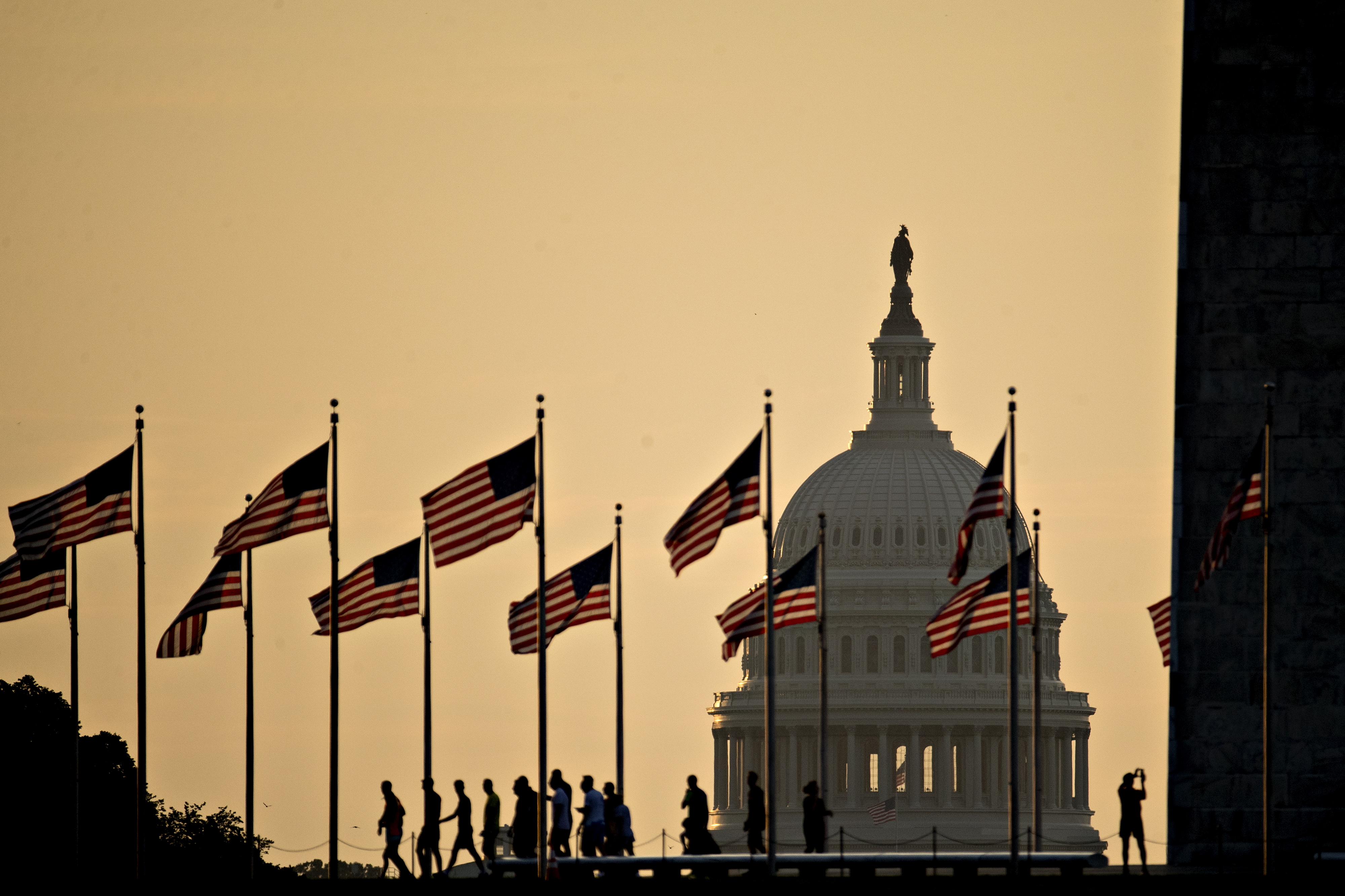 The U.S. Capitol building stands past visitors at the Washington Monument in Washington, D.C., U.S., on Tuesday, July 11, 2017. (Andrew Harrer—Bloomberg via Getty Images)