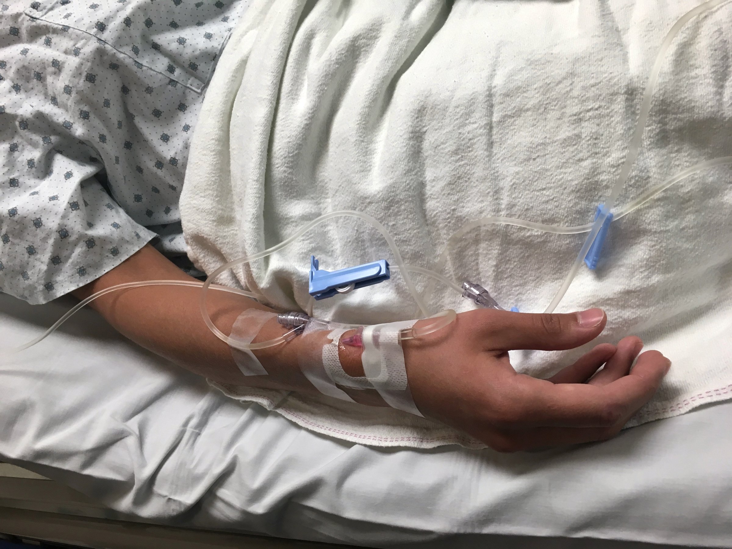 Patient in Hospital bed with IV in arm