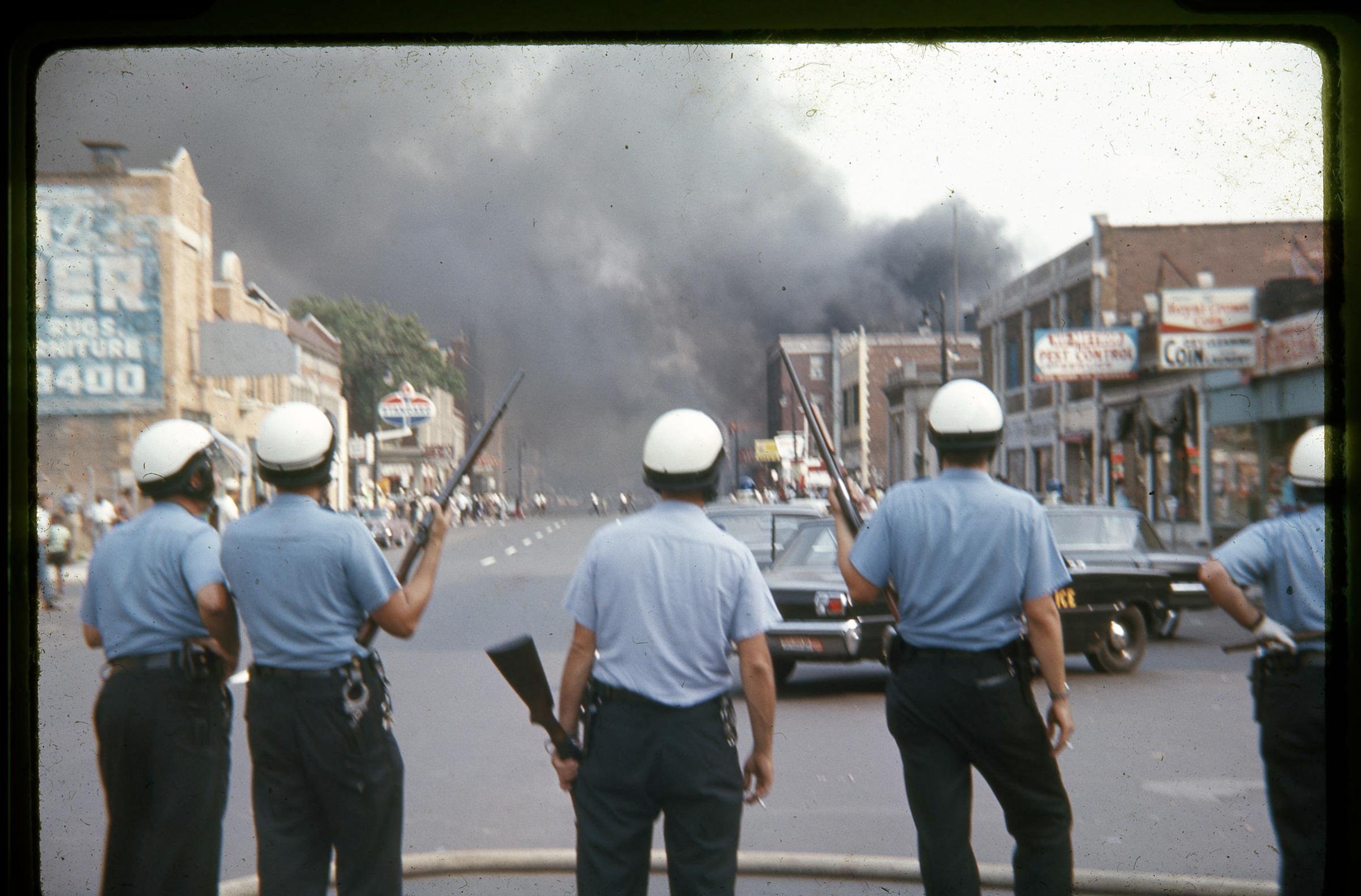 Detroit police officers standing on Linwood Avenue on the west side of Detroit during the July 1967 riots.