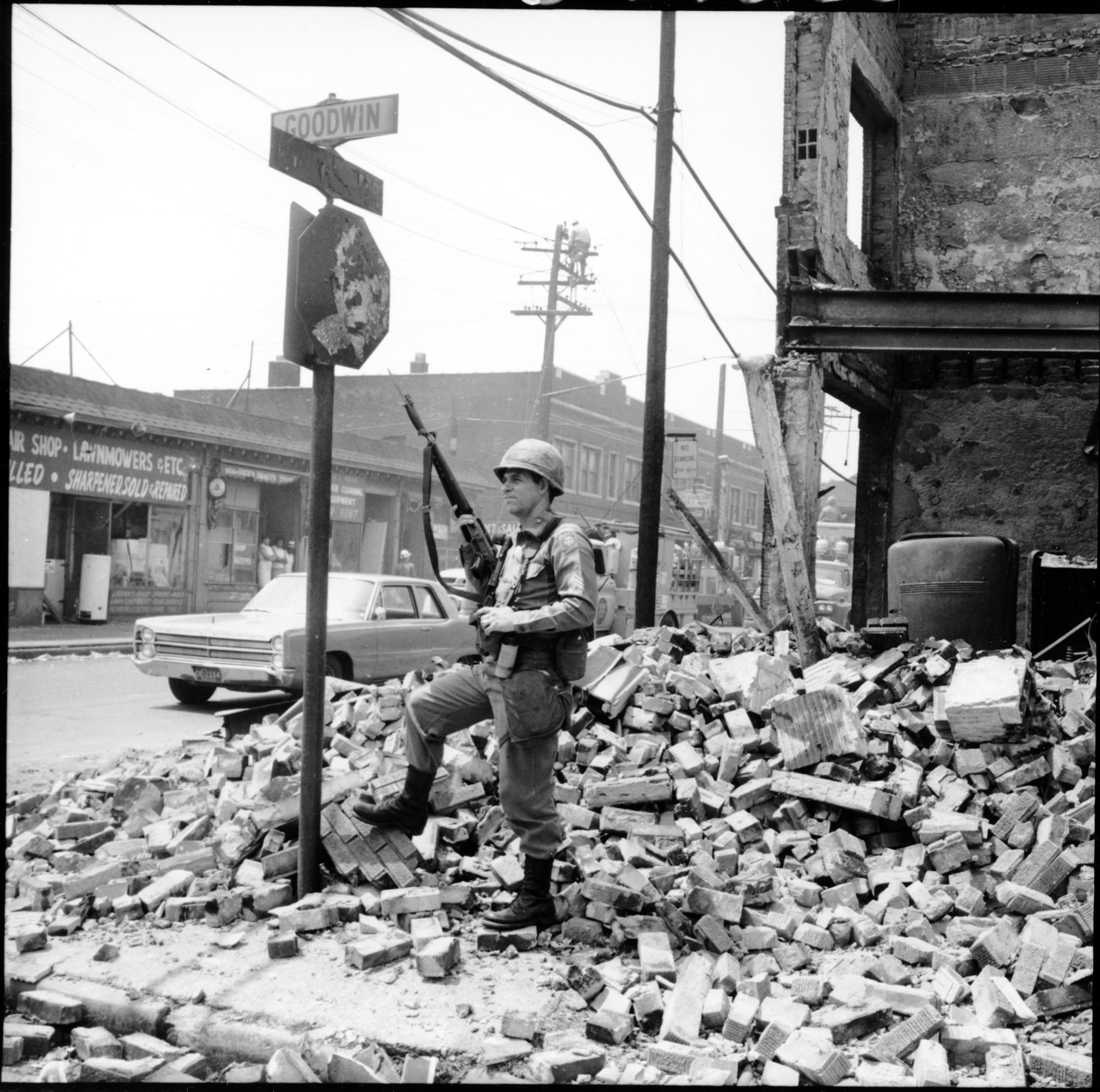 A Sargent from the U.S. Airborne Division stands guard at the corner of Westminster and Goodwin Streets in Detroit during the violence and chaos that took place in July ’67.