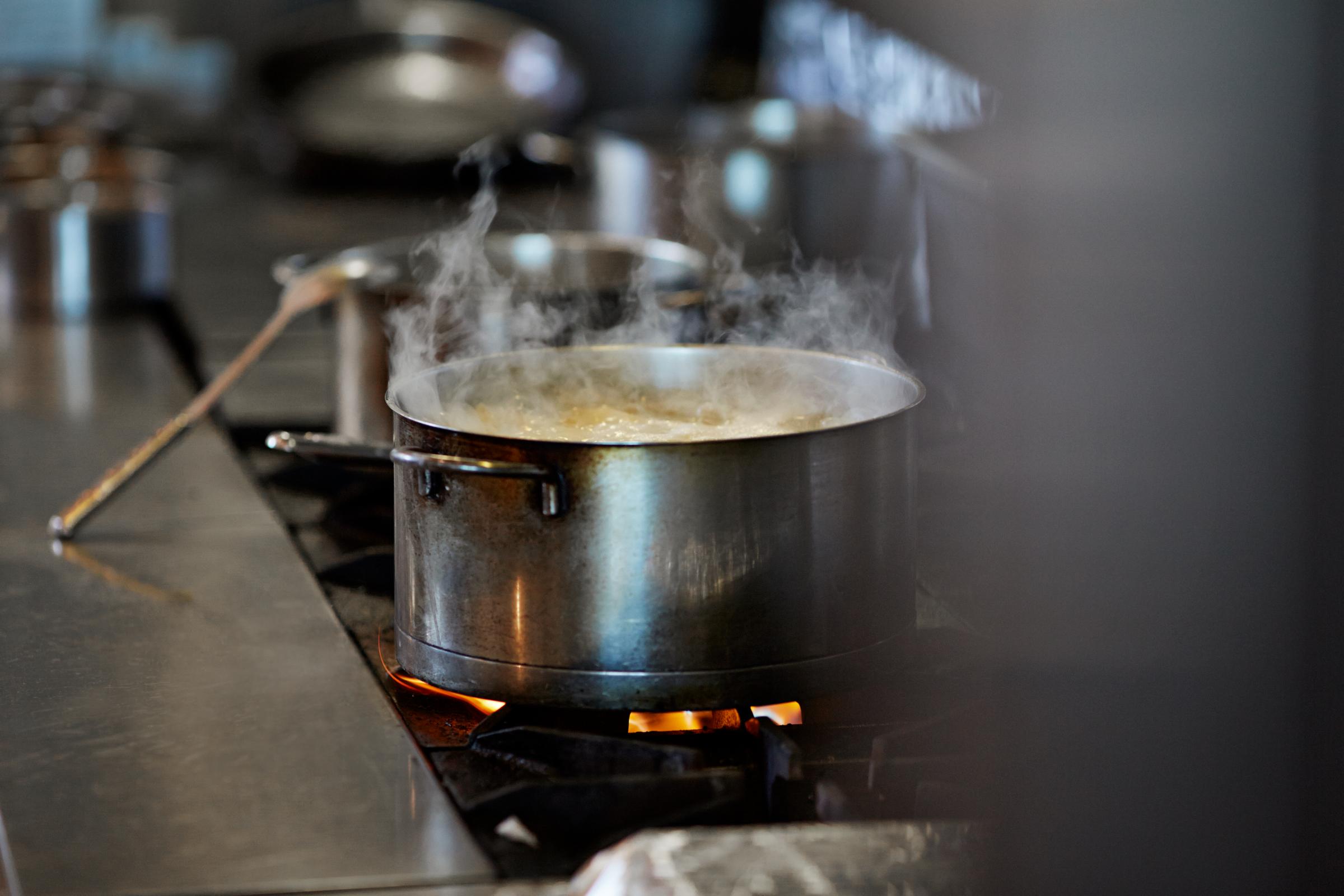 Font cooking on stow in kitchen at restaurant