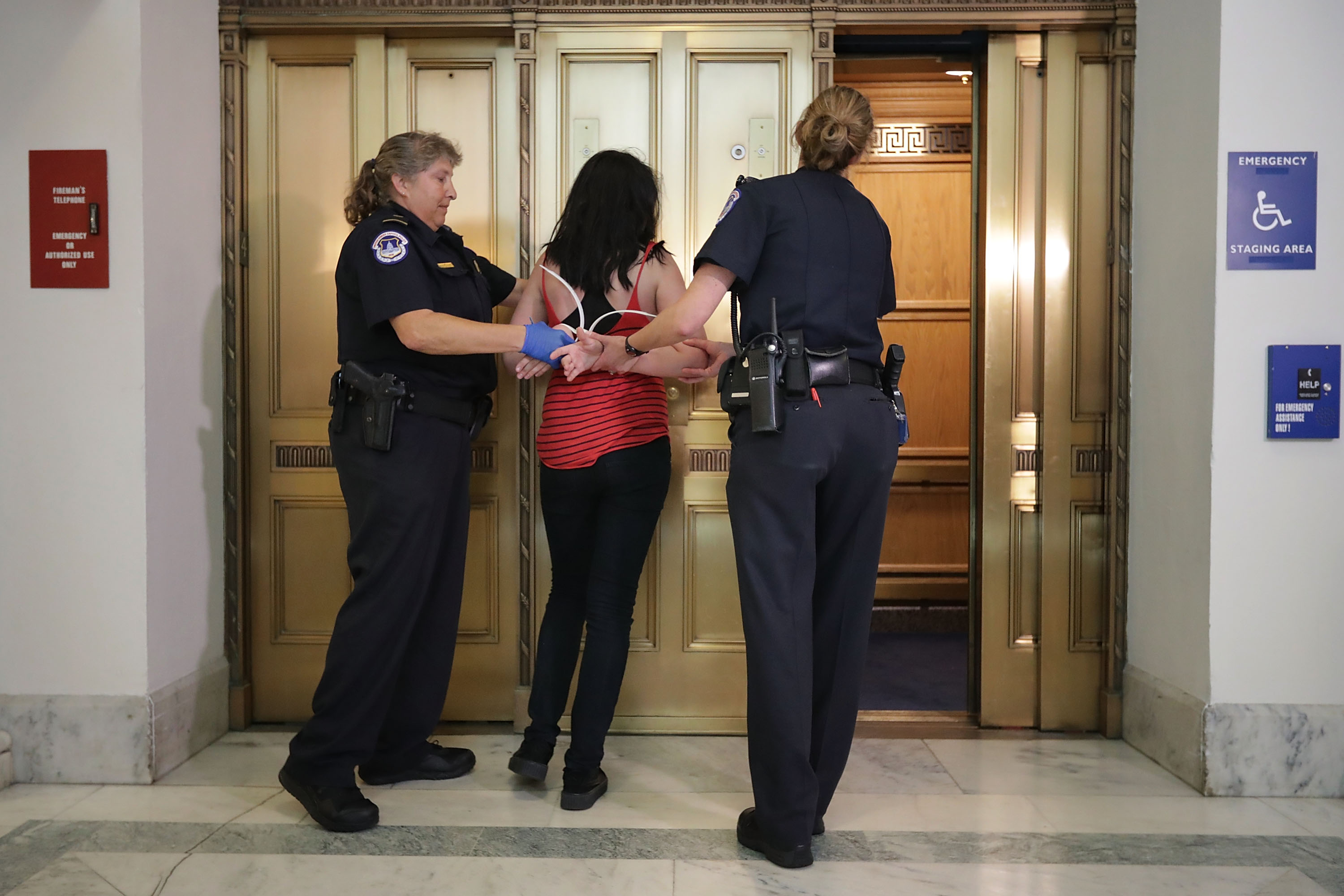 U.S. Capitol Police officers arrest a protester who was demonstrating against Republican health care reform legislation outside the offices of Sen. Jeff Flake (R-AZ) in the Russell Senate Office Building on Capitol Hill, July 10, 2017 in Washington. (Chip Somodevilla&mdash;Getty Images)
