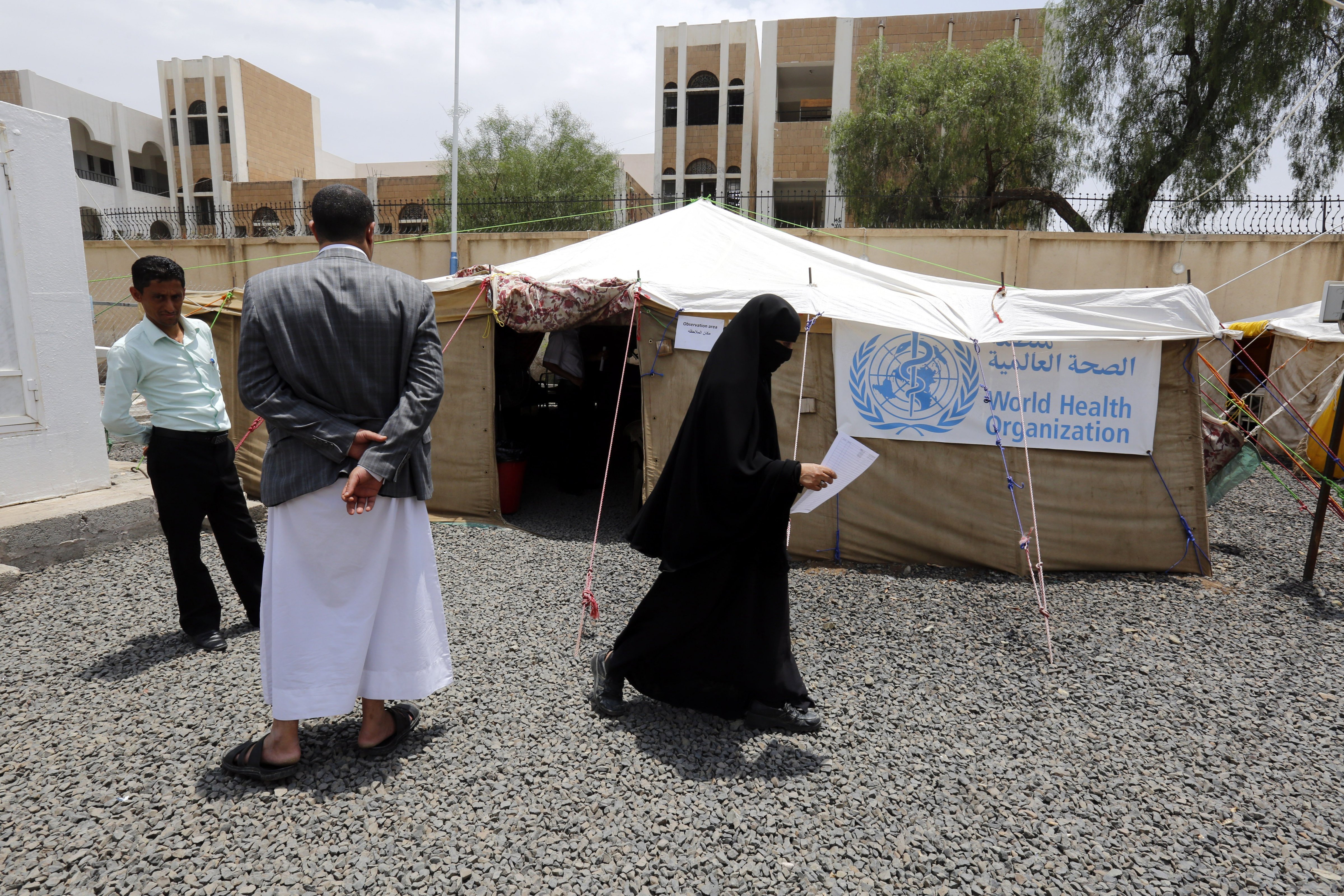 Yemenis stand outside makeshift tents receiving cholera cases amid an acute cholera outbreak, at a hospital in Sanaa, Yemen, July 22, 2017. (Yahya Arhab—EPA)