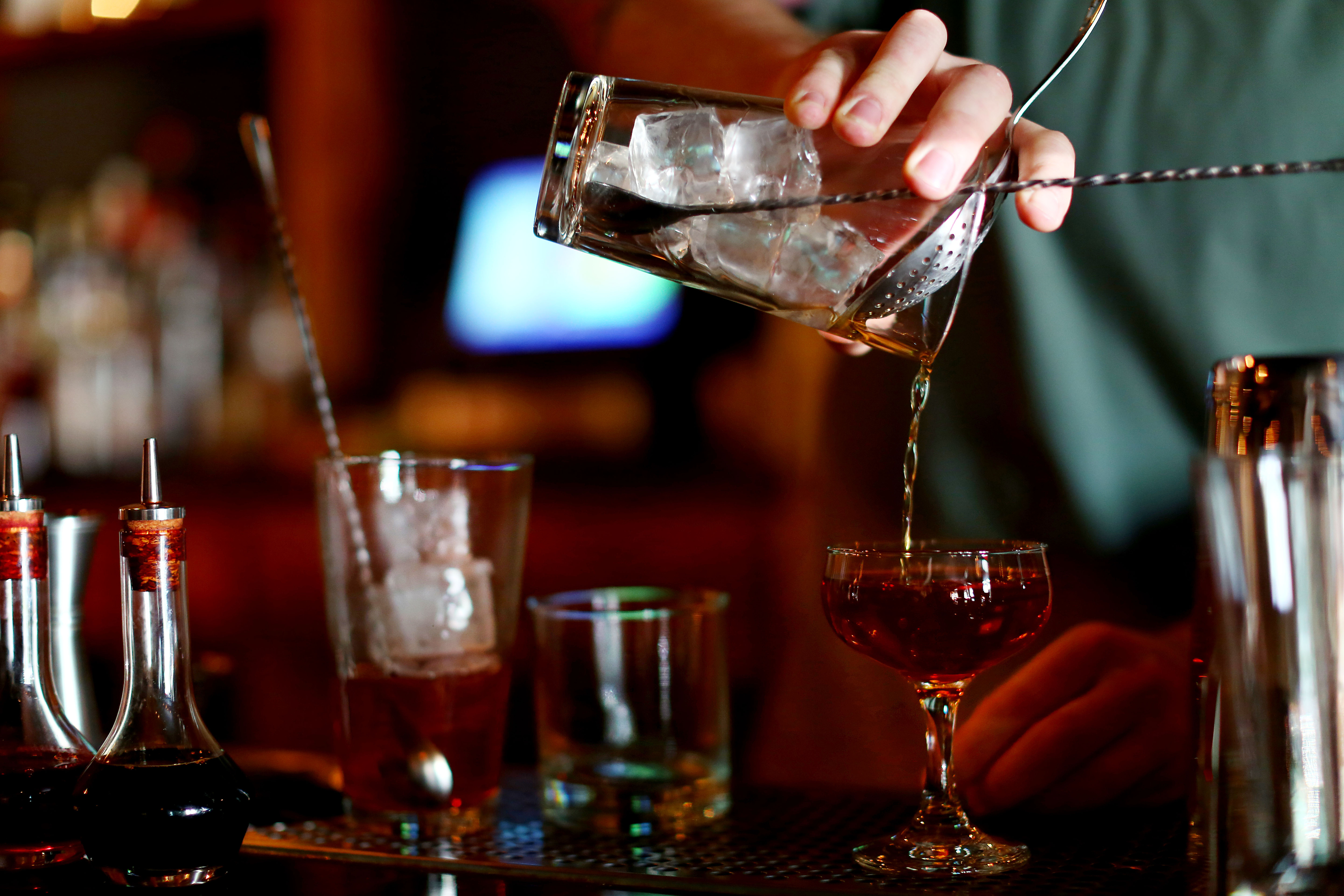 A bartender mixes up a whiskey cocktail in a bar (Marianna Massey - Getty Images)
