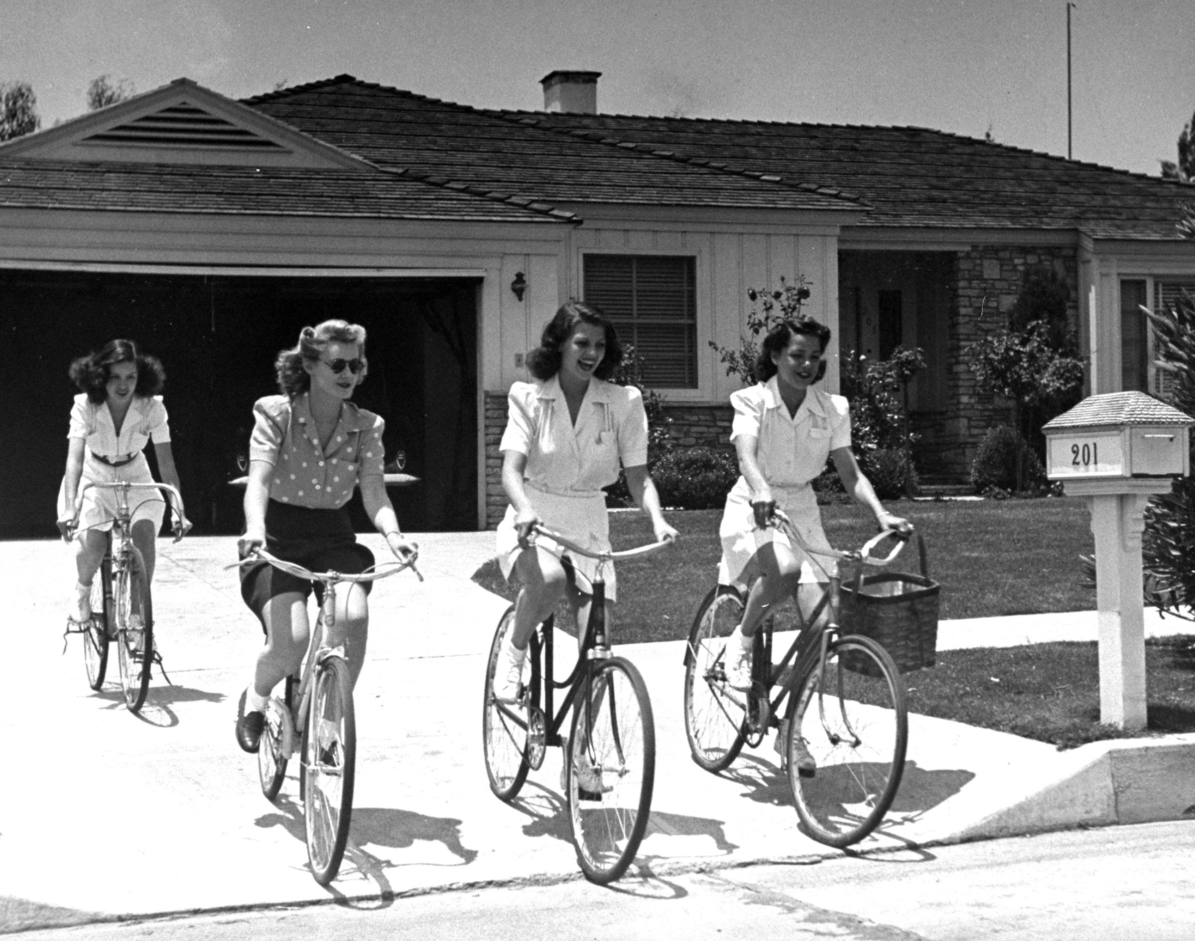 Actress Rita Hayworth (2R) riding bikes with her friends Minerva Griswold, Jane Hopkins and Virginia Hovey, 1940.