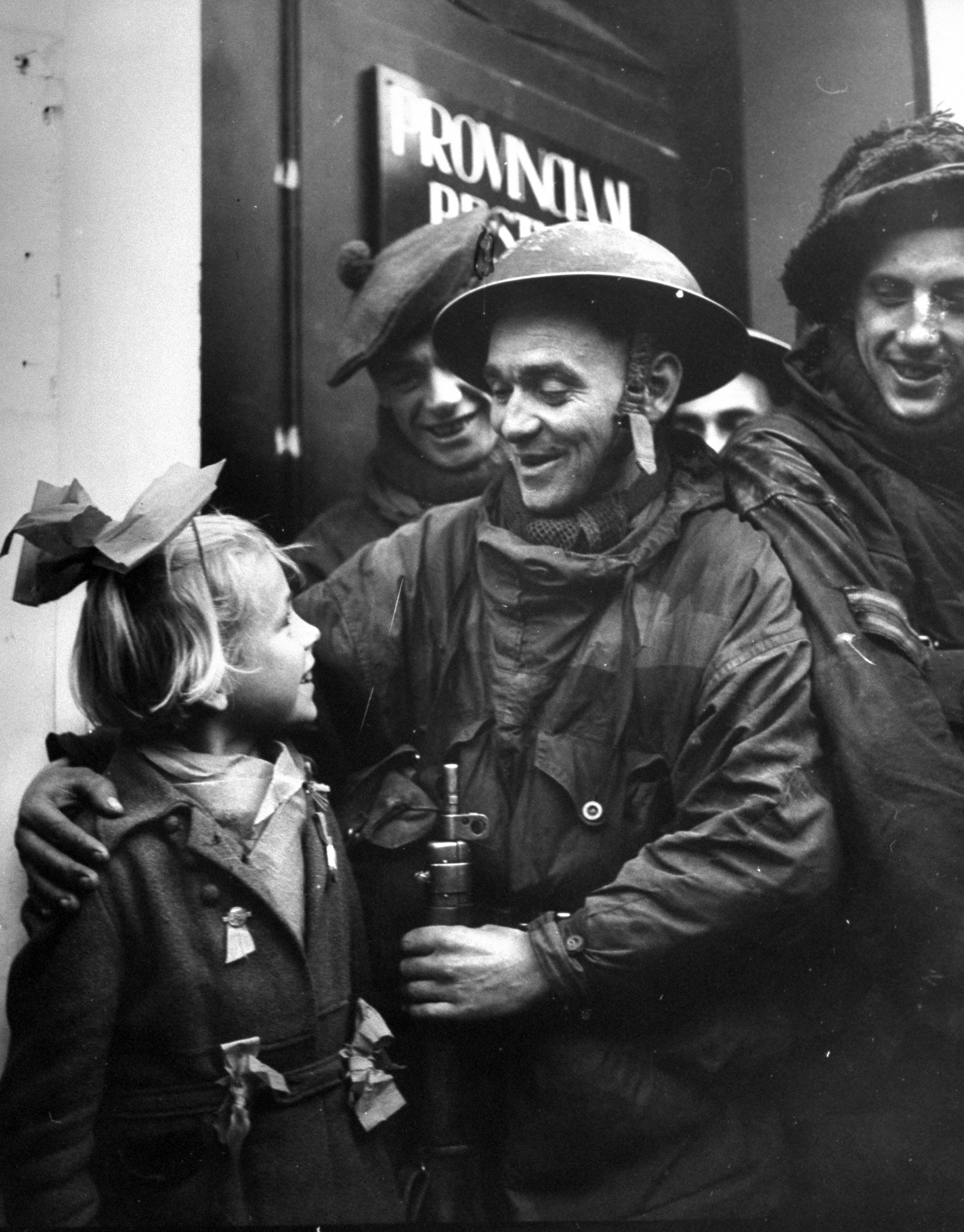 A Scotch tommy making friends with a little Dutch girl, 1944.