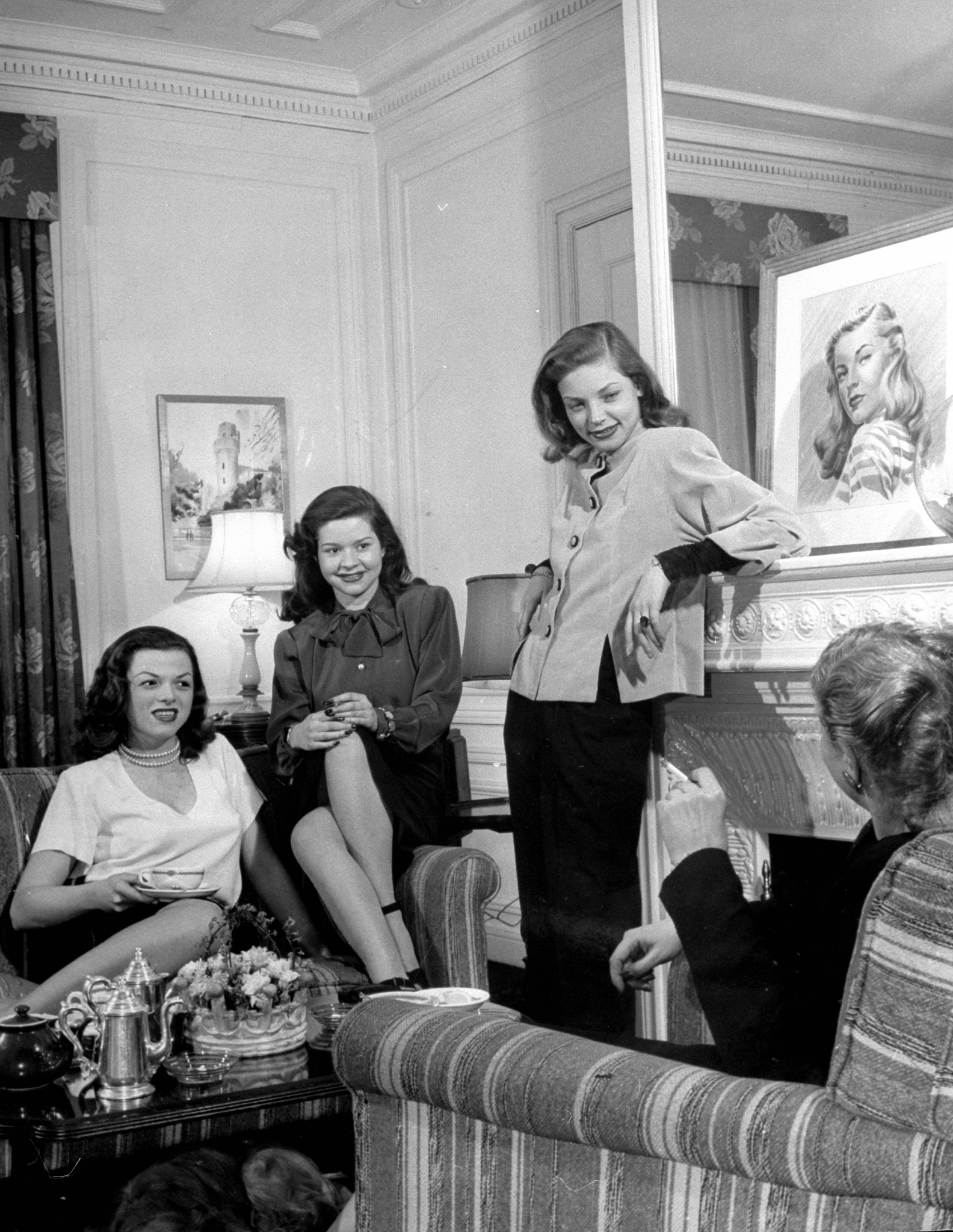 Lauren Bacall with friends at the Gotham Hotel, 1945.