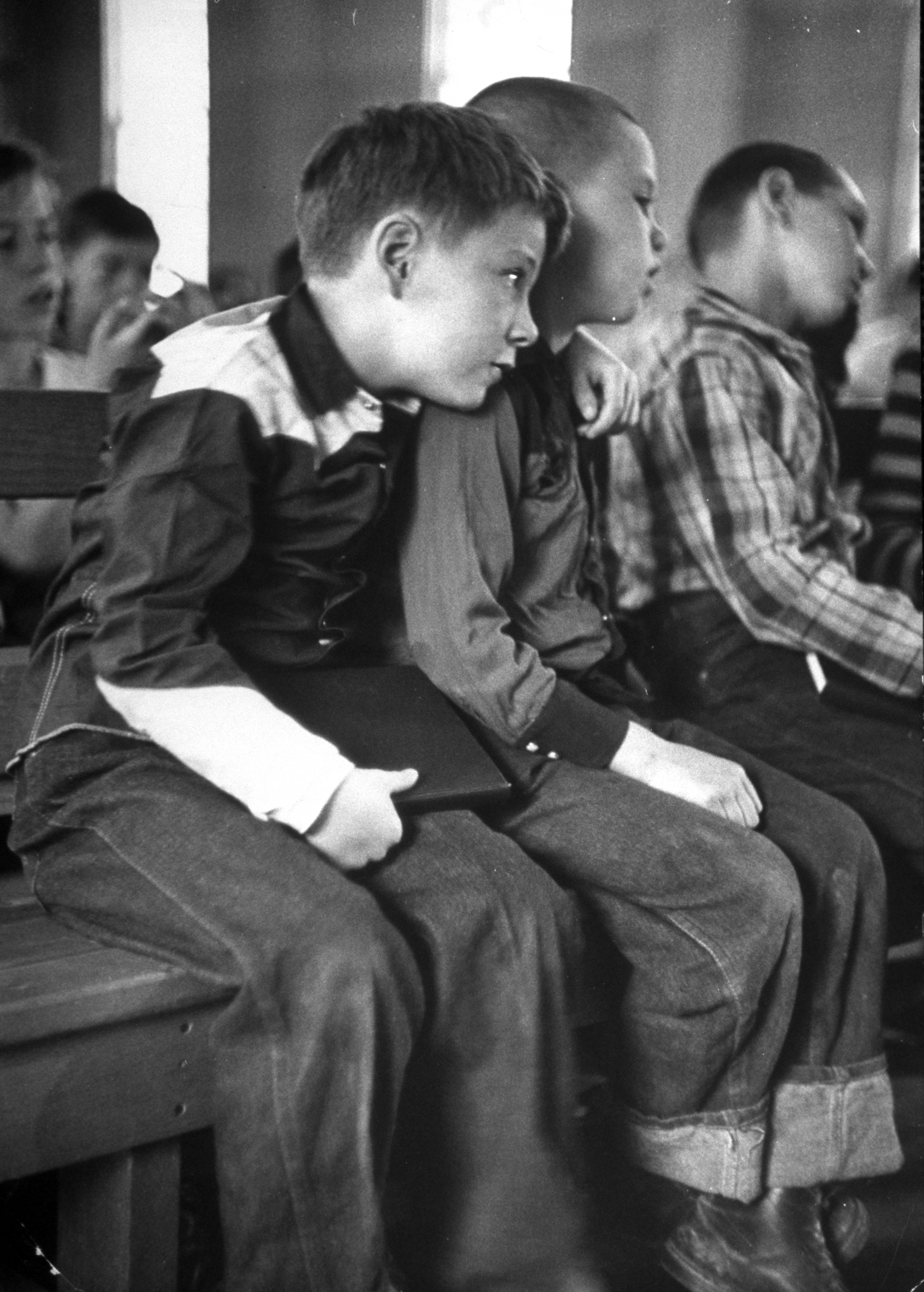 Young Richard Dale (L) beginning to adjust to his new environment when he finds a new friend, Ernest, during chapel services at boy's ranch.