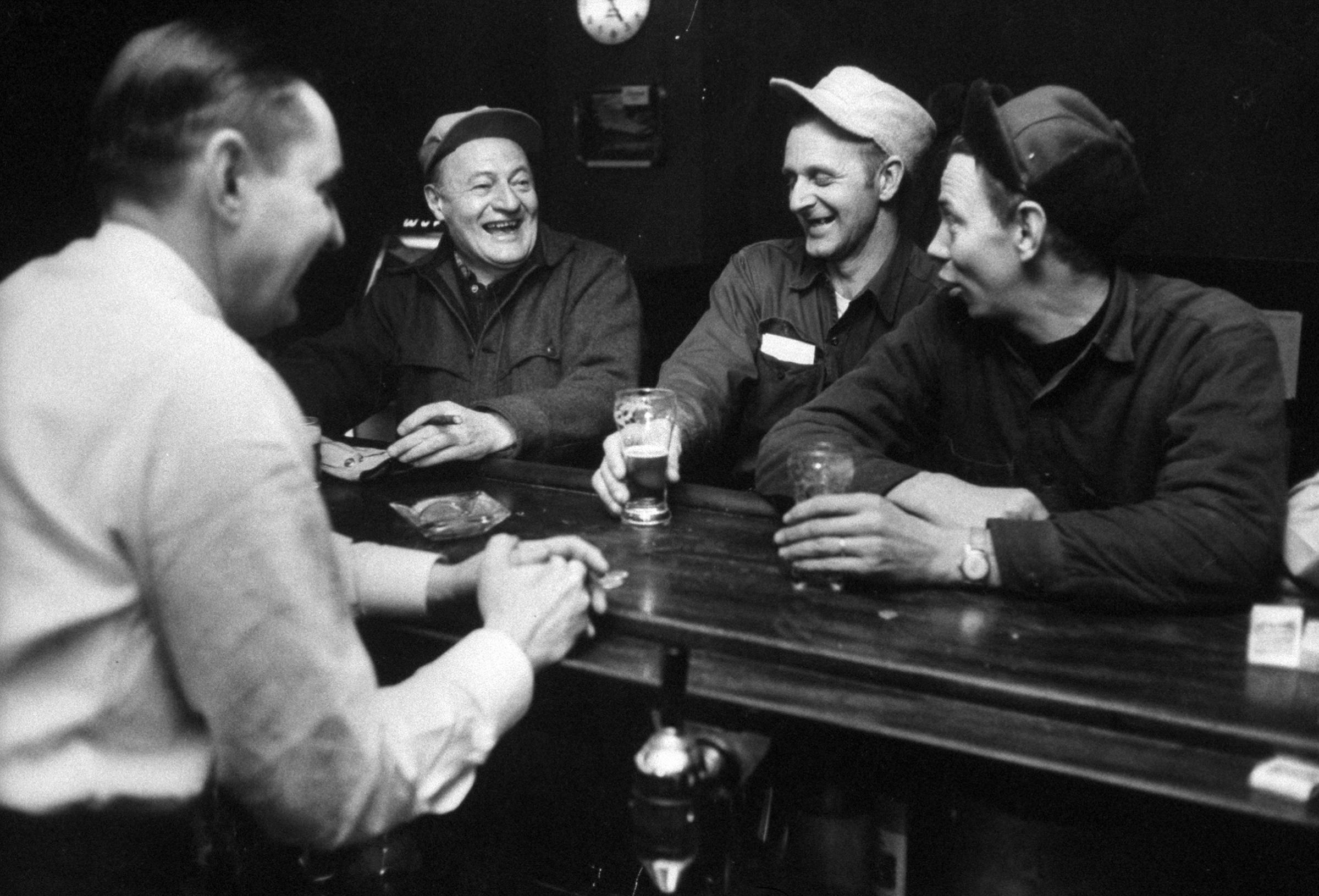 Judge John D. Voelker relaxing with friends in a tavern, 1958.