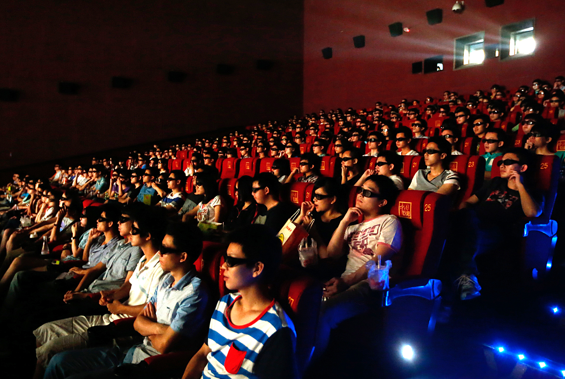 An audience watches "Transformers - Age Of Extinction" through 3D glasses at a cinema on June 27, 2014 in Wuhan, Hubei province, China. (VCG via Getty Images)