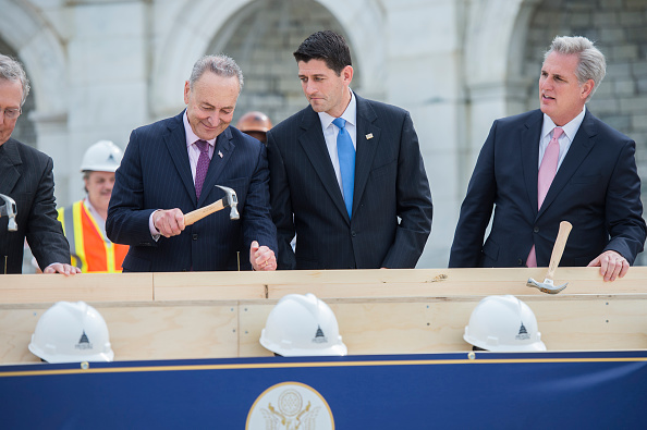 Speaker Paul Ryan, R-Wis., reacts to the technique of Sen. Charles Schumer, D-N.Y., as Senate Majority Leader Mitch McConnell, R-Ky., far left, and House Majority Leader Kevin McCarthy, R-Calif., participate in a First Nail Ceremony that launches the construction of the Inaugural platform on the West Front of the Capitol, September 21, 2016. (Tom Williams—CQ-Roll Call,Inc.)