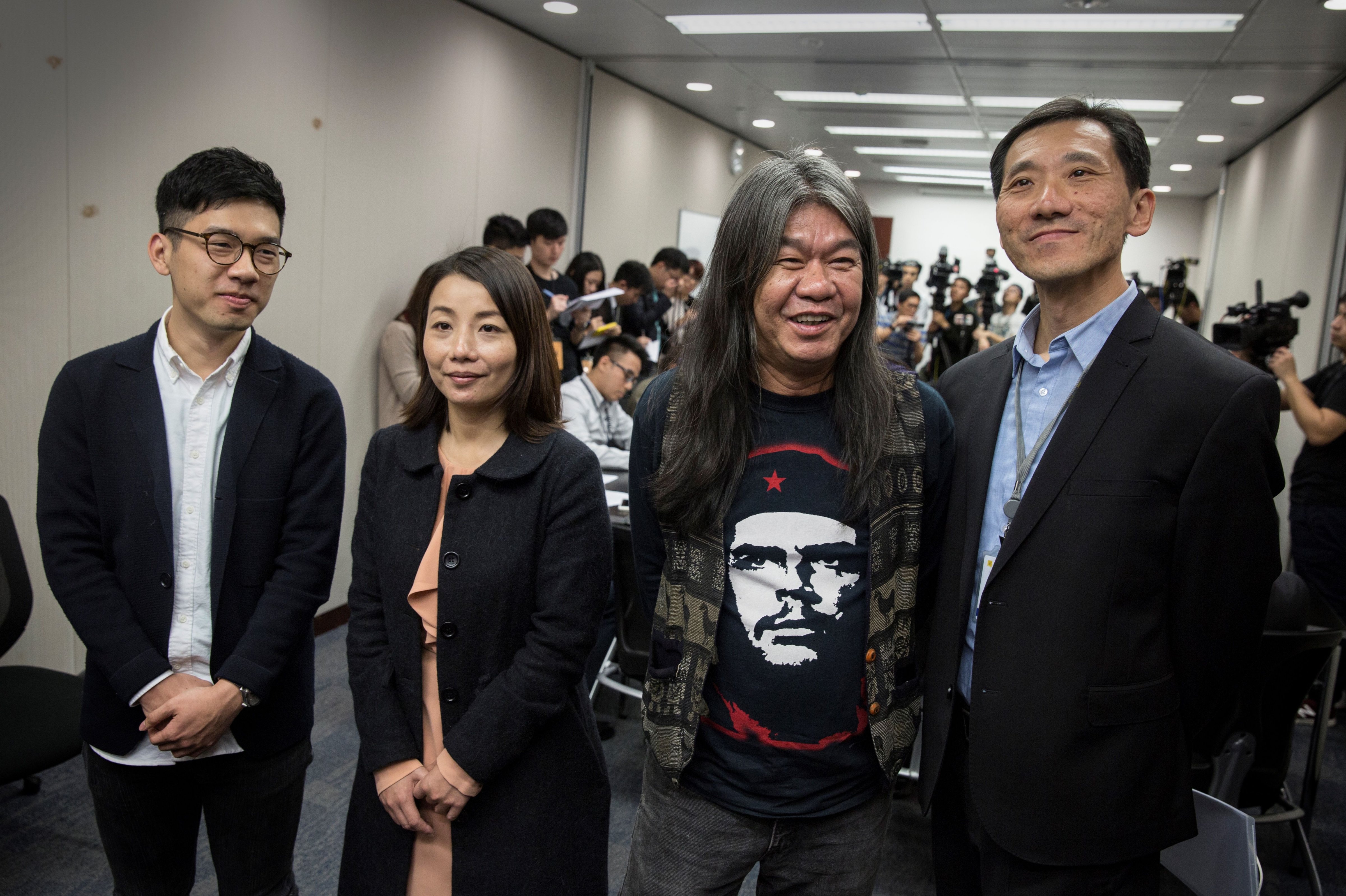 This Dec. 22, 2016 phoyo shows Hong Kong Legislative Council members Nathan Law (L), Lau Siu-lai (2nd L), Leung Kwok-hung (2nd R) and Edward Yiu (R) at a press conference addressing the judicial review brought by the government over each of their oath-taking. (Isaac Lawrence—AFP/Getty Images)