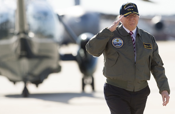 US President Donald Trump salutes as he walks to Air Force One prior to departing from Langley Air Force Base in Virginia, March 2, 2017, as he traveled to Newport News, Virginia, to visit the pre-commissioned USS Gerald R. Ford aircraft carrier.
