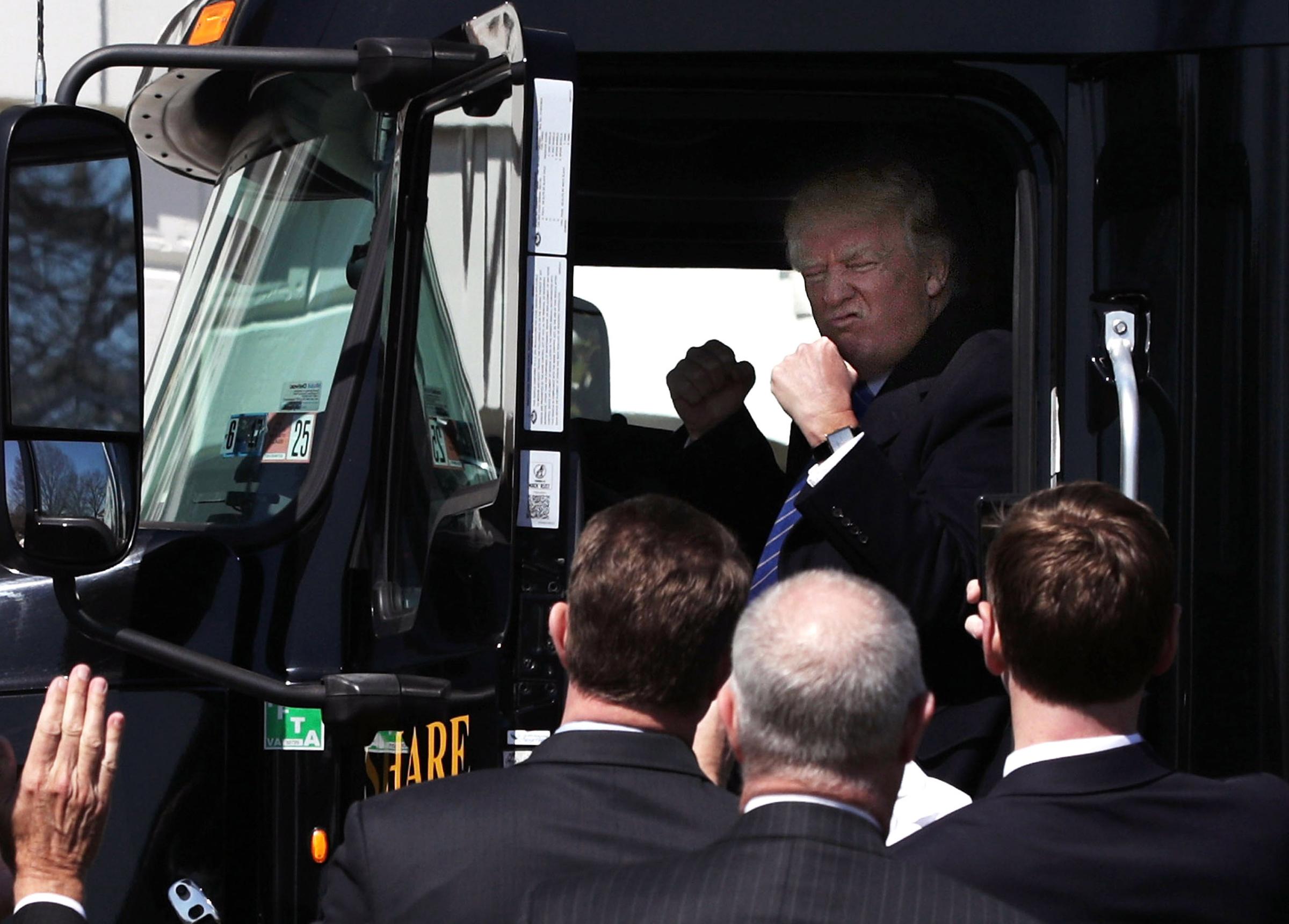 U.S. President Donald Trump sits in the cab of a truck as he welcomes members of American Trucking Associations to the White House March 23, 2017 in Washington, DC.
