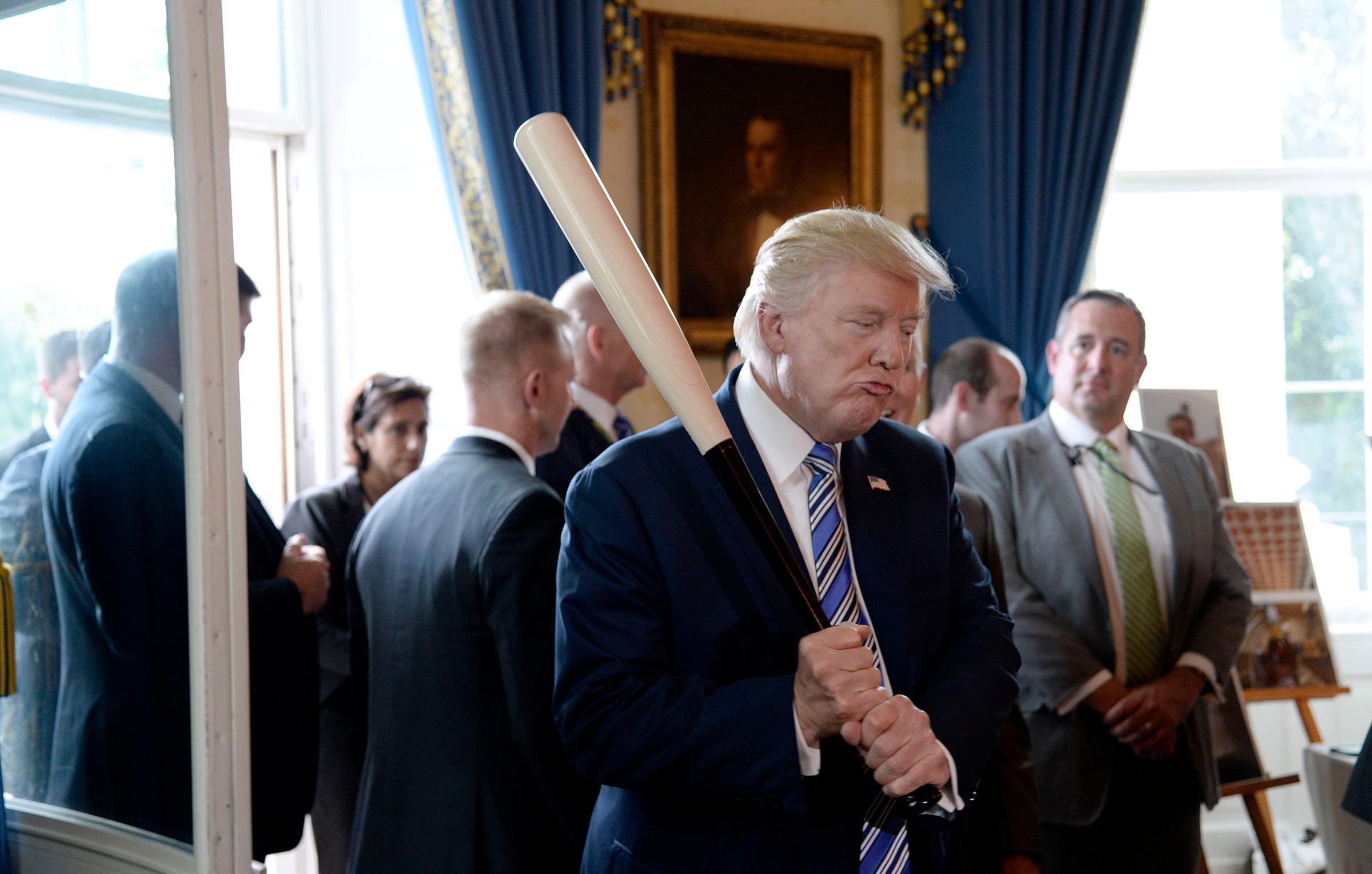 US President Donald Trump examines US-made products from all 50 states, including a Marucci baseball bat, in the Blue Room of the White House during a "Made in America" product showcase event in Washington, DC, on July 17, 2017.