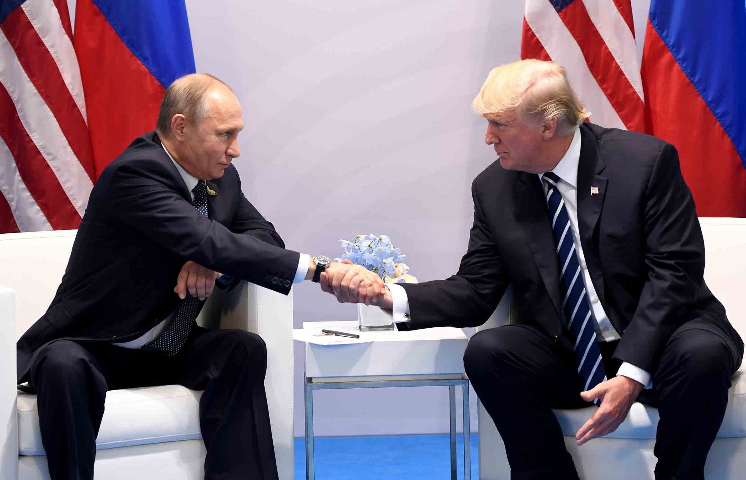 President Donald Trump and Russia's President Vladimir Putin shake hands during a meeting on the sidelines of the G20 Summit in Hamburg, Germany, on July 7, 2017.