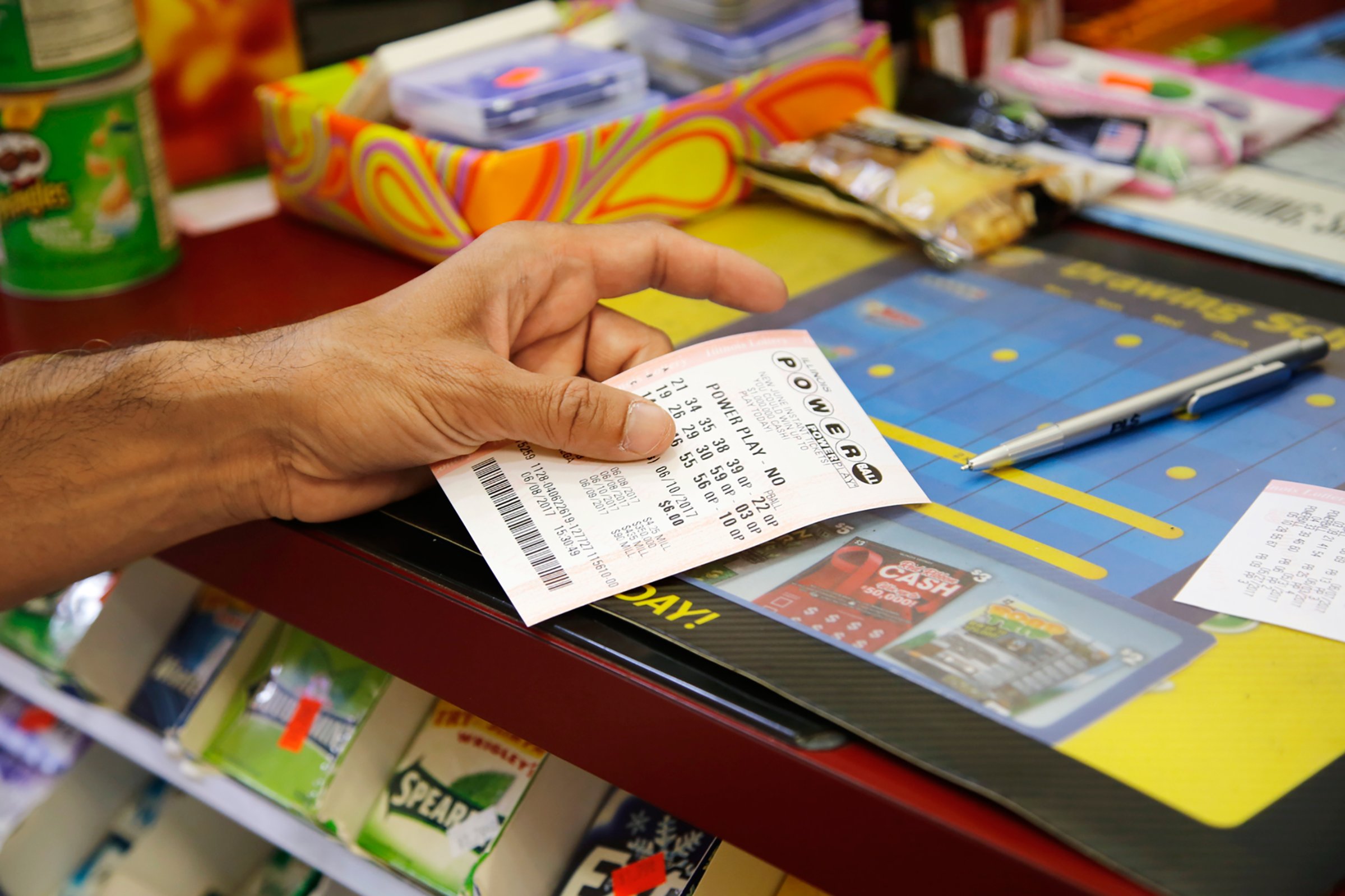 A customer buys a Powerball ticket, June 8, 2017, in Chicago.