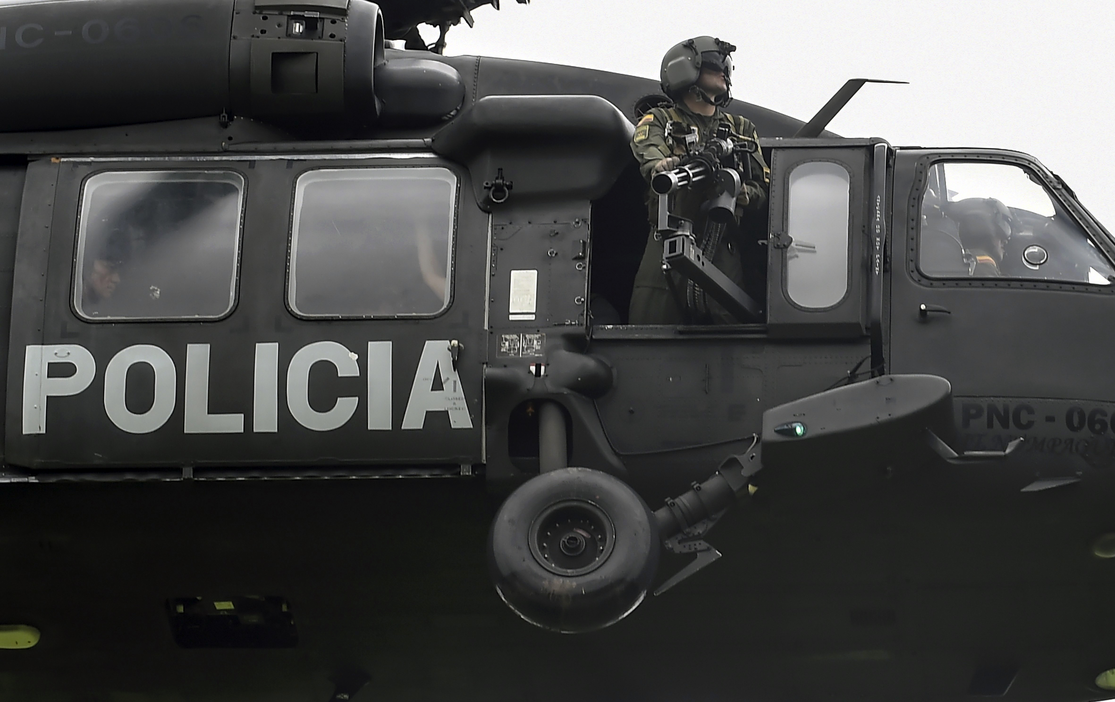 A helicopter used by Colombia's anti-narcotics police to throw pamphlets offering rewards for information leading to the capture of members of the Gulf Clan cartel overflies Apartado in Antioquia department, Colombia as part of the Agamemnon anti-drug trafficking operation on May 31, 2017. (RAUL ARBOLEDA&mdash;AFP/Getty Images)