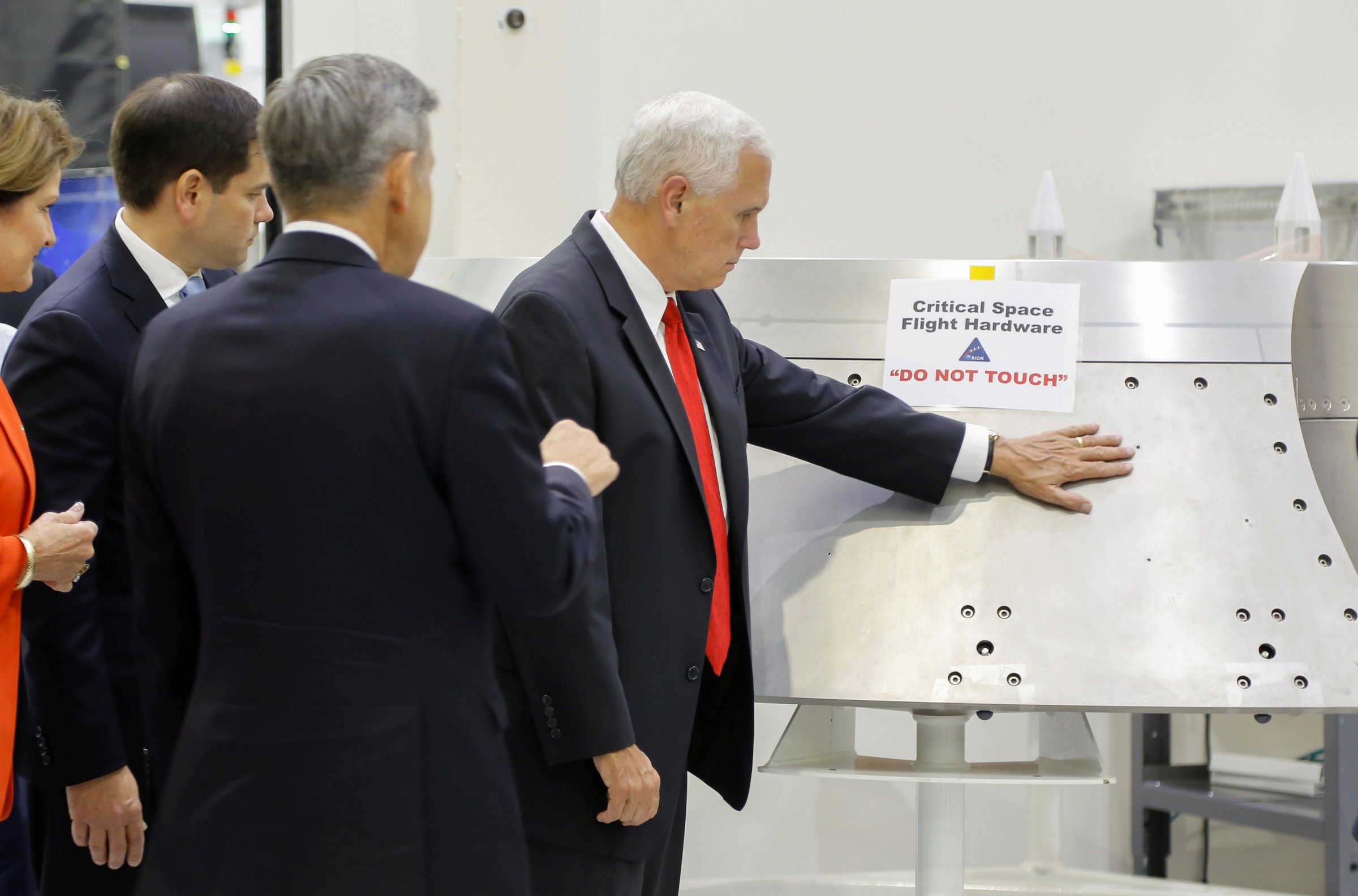 Vice President Mike Pence is shown a piece of hardware by Kennedy Space Center Director Robert Cabana during a tour of the Operations and Checkout Building in Florida, July 6, 2017.