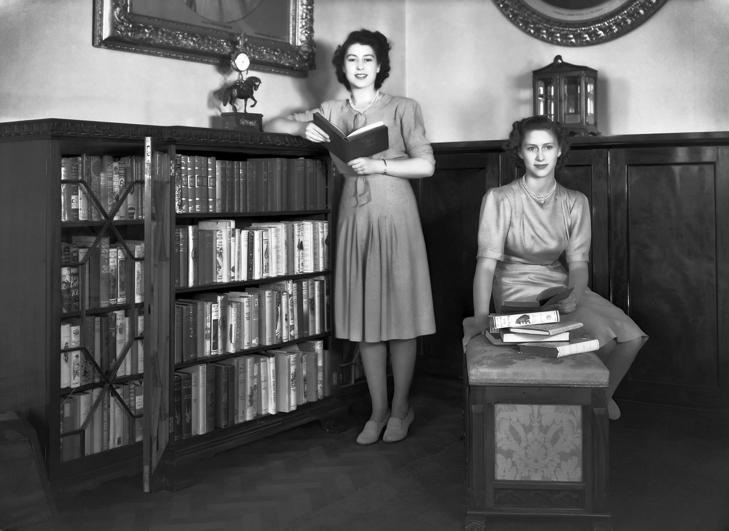 Princess Elizabeth and her sister Princess Margaret in a library in Buckingham Palace on July 19, 1946.