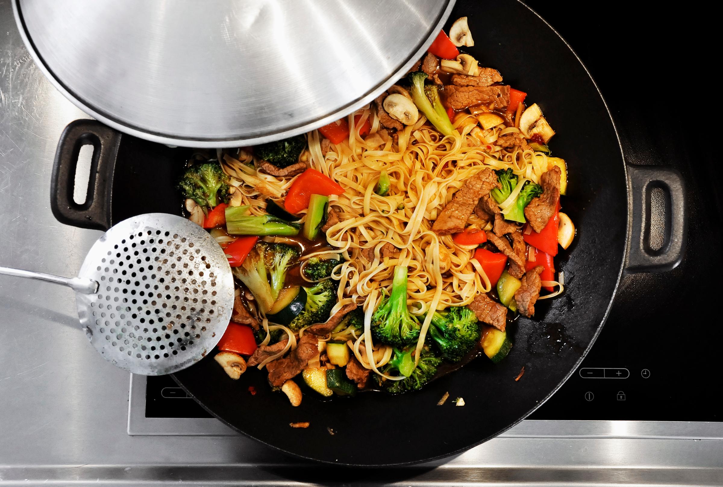 Cooking vegetable stir-fry in a wok