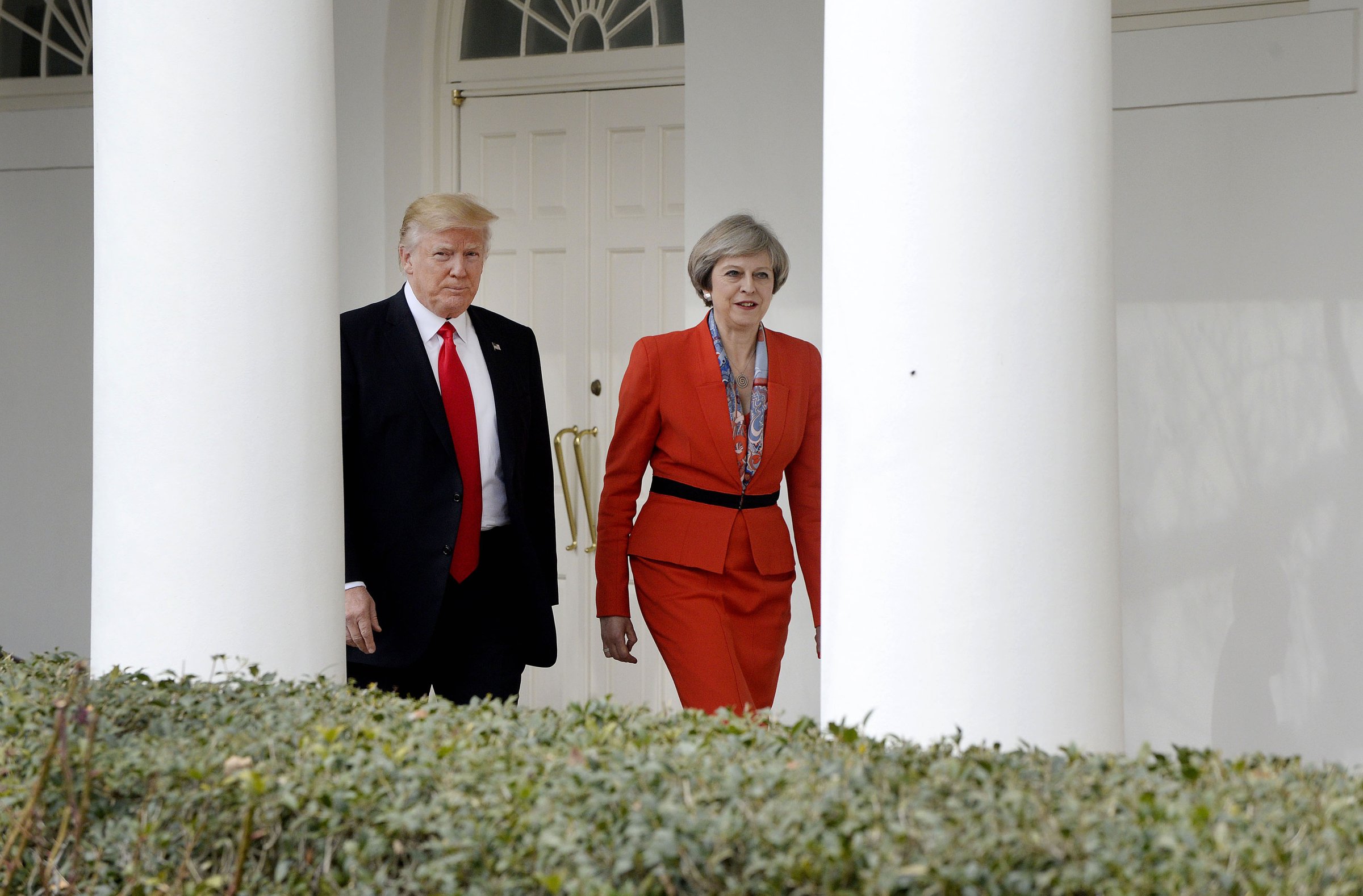 President Donald Trump, left, walks with Theresa May, U.K. prime minister, outside of the White House in Washington, on Jan. 27, 2017.