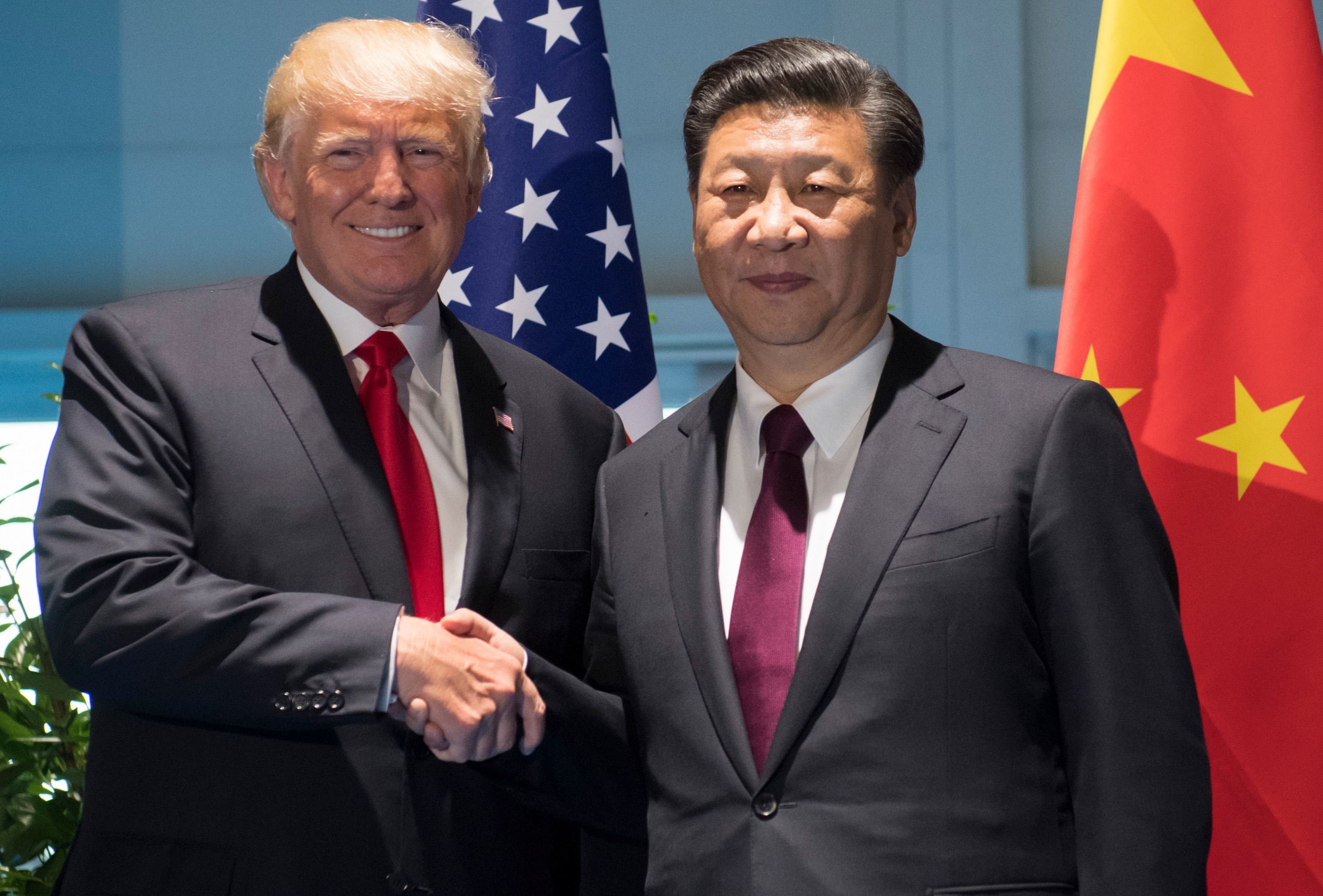 US President Donald Trump and Chinese President Xi Jinping (R) shake hands prior to a meeting on the sidelines of the G20 Summit in Hamburg, Germany, July 8, 2017. (SAUL LOEB&mdash;AFP/Getty Images)