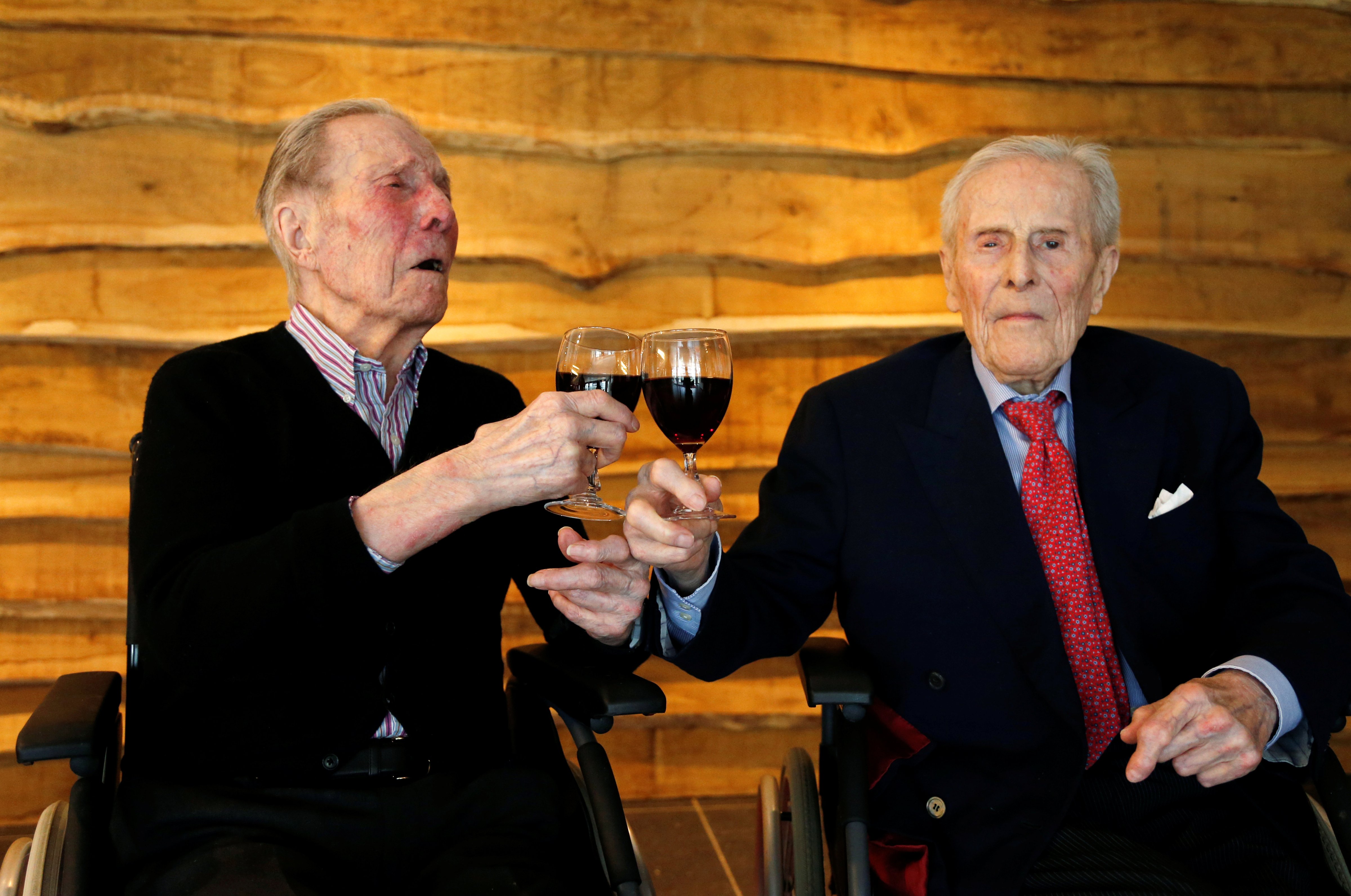 The world's oldest living twin brothers, Paulus and Pieter Langerock from Belgium, 102, toast with a glass of red wine at the Ter Venne retirement home in Sint-Martens-Latem