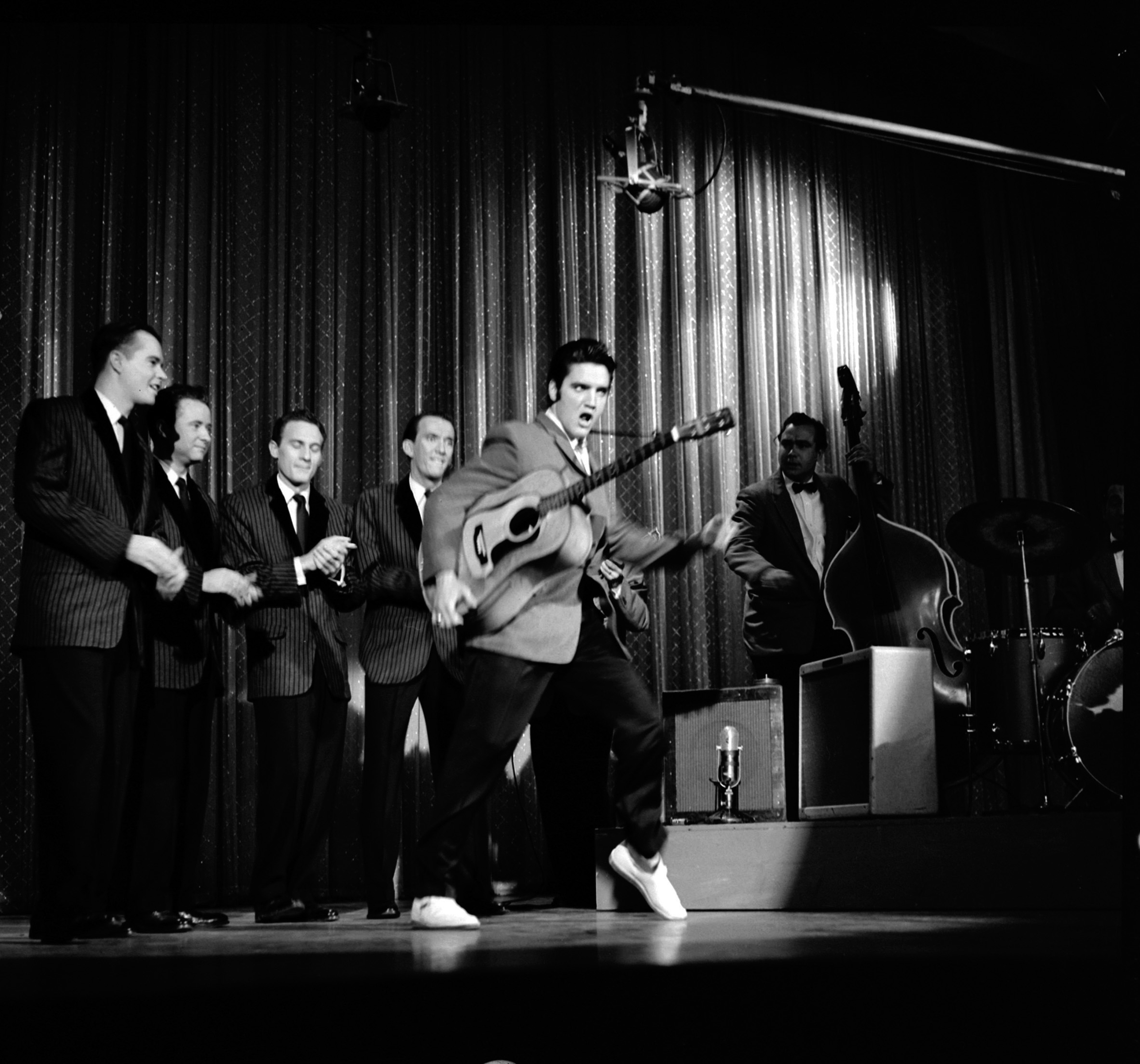 Elvis swivels his hips as he performs with his band onstage during his second appearance on 'The Ed Sullivan Show,' New York, N.Y., Oct. 28, 1956.