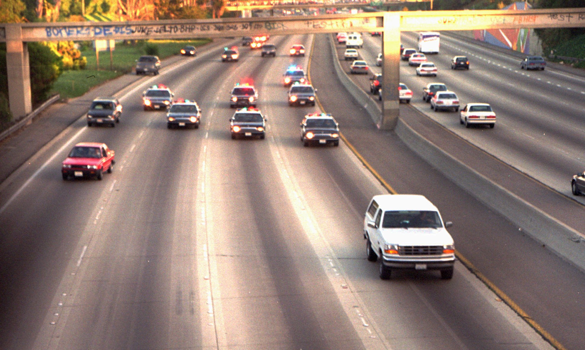 A white Ford Bronco, driven by Al Cowlings and carrying O.J. Simpson, is trailed by police cars as it travels on a southern California freeway on June 17, 1994, in Los Angeles. (Joseph Villarin—AP)