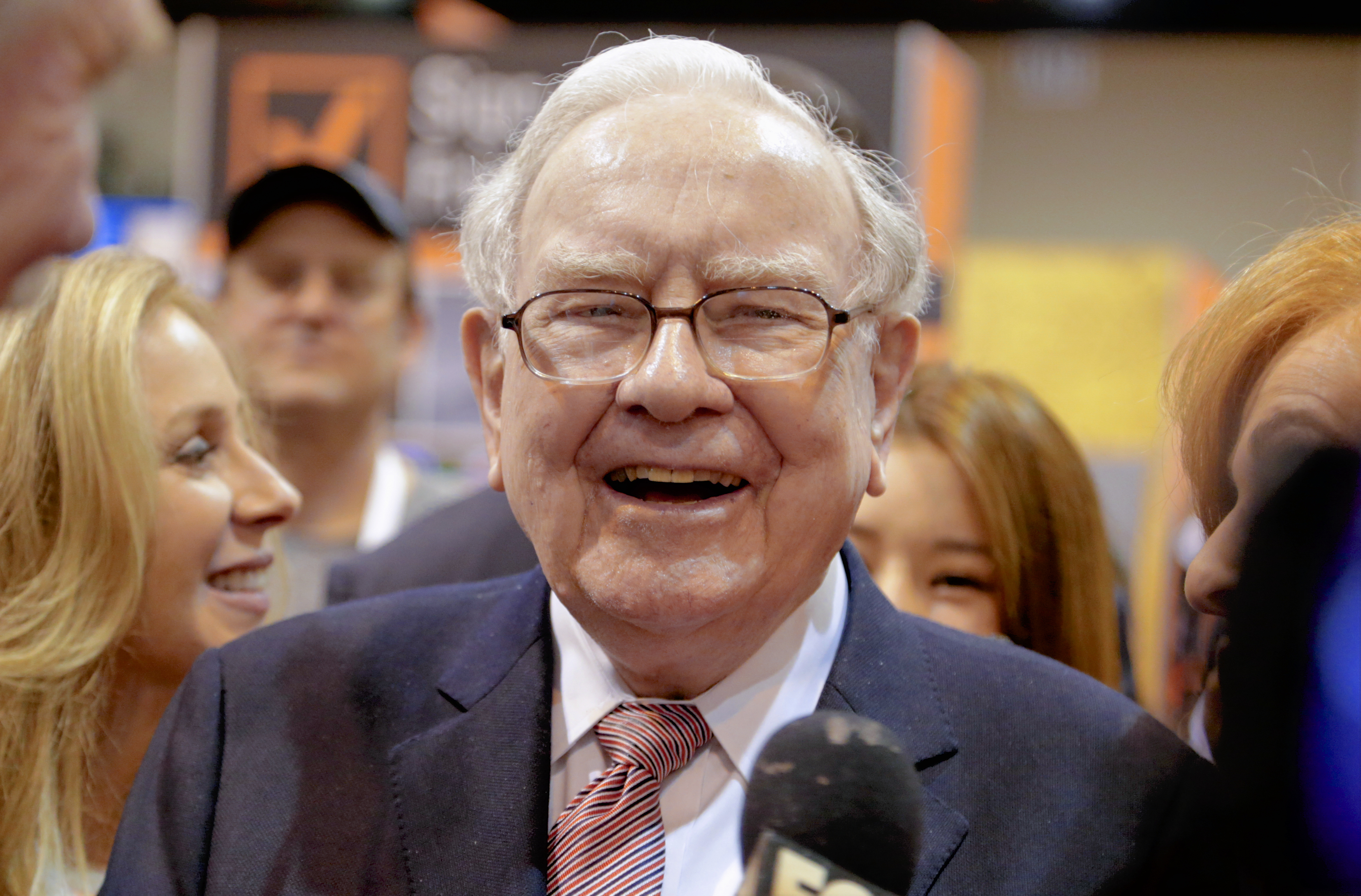 Berkshire Hathaway Chairman and CEO Warren Buffett laughs while touring the exhibit floor at the CenturyLink Center in Omaha, Neb., Saturday, May 6, 2017, where company subsidiaries display their products. (Nati Harnik—AP)