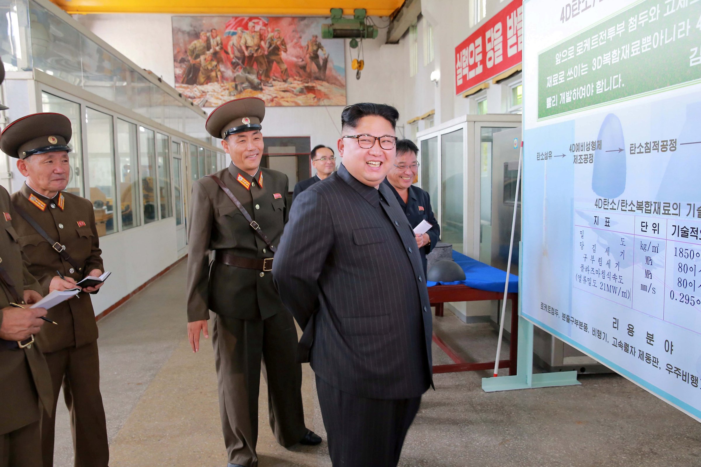 North Korean leader Kim Jong-Un smiles during a visit to the Chemical Material Institute of the Academy of Defense Science