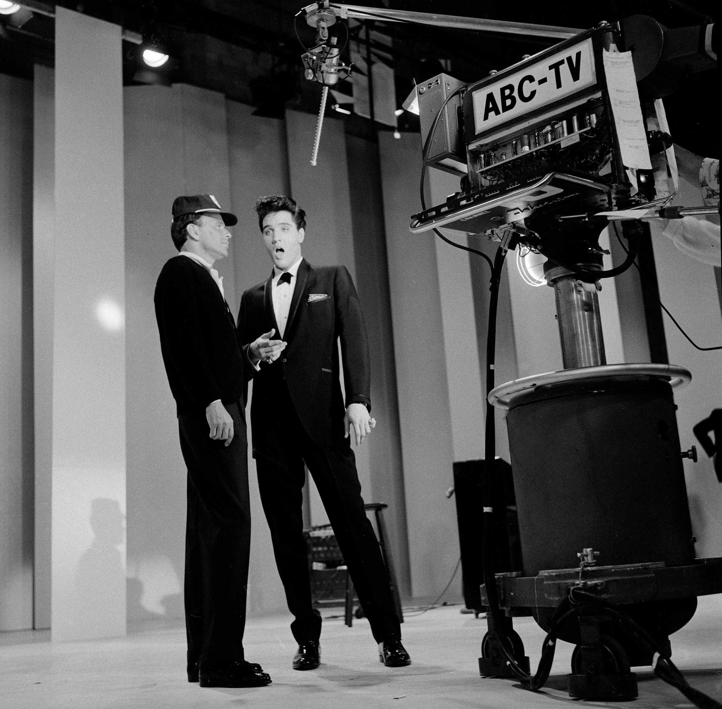 Frank Sinatra (left) welcomed special guest star Elvis Presley home from the Army. A highlight from the show featured a medley by Sinatra and Presley of each other's songs. 1960.