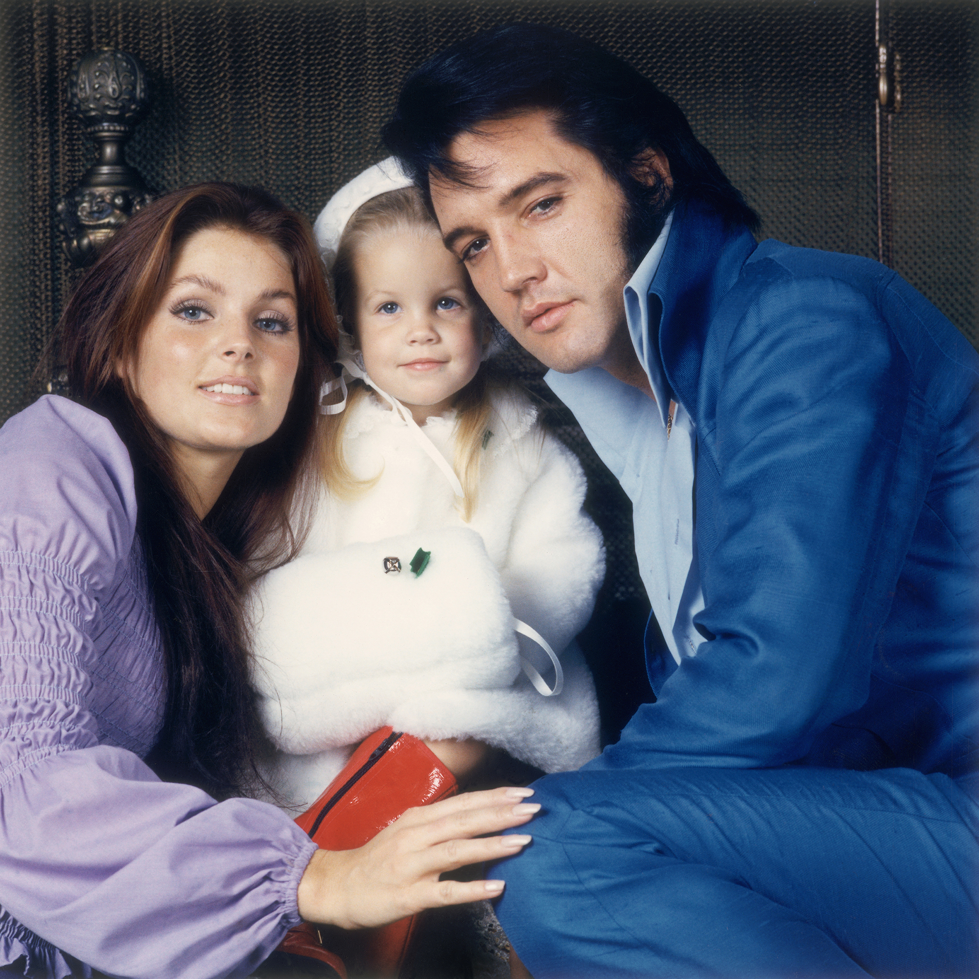 Elvis with his wife Priscilla and their daughter Lisa-Marie pose for a portrait, 1970's.