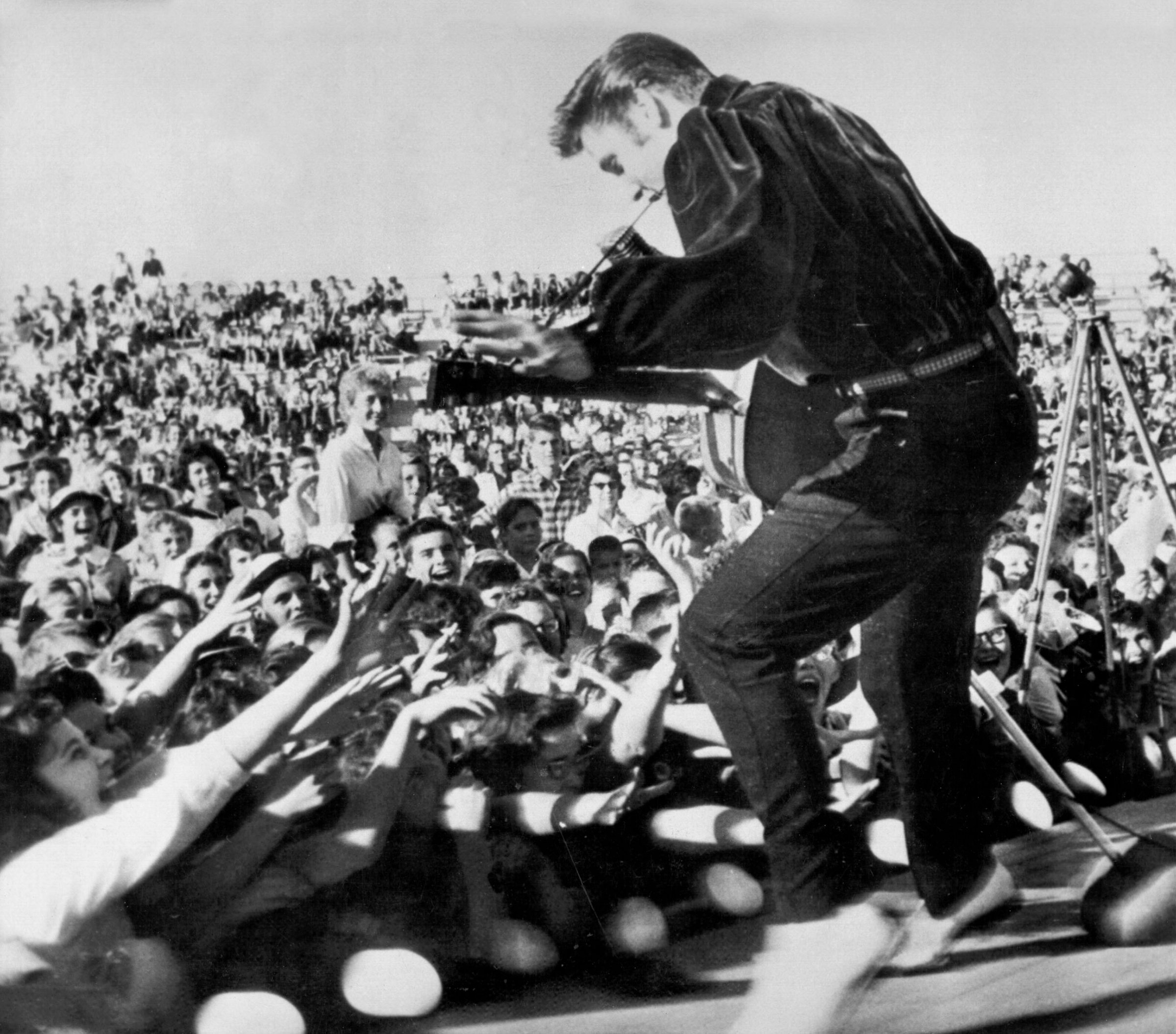 Elvis performs outside to adoring fans on September 26, 1956 in his hometown of Tupelo, Mississippi.