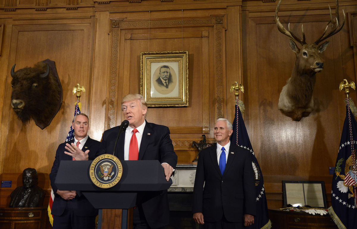 U.S. President Donald Trump, center, speaks while Ryan Zinke, U.S. secretary of interior, left, and U.S. Vice President Mike Pence before signing an executive order about the antiquities act at the Department of the Interior in Washington, D.C., April 26, 2017. (Mike Theiler—Bloomberg via Getty Images)