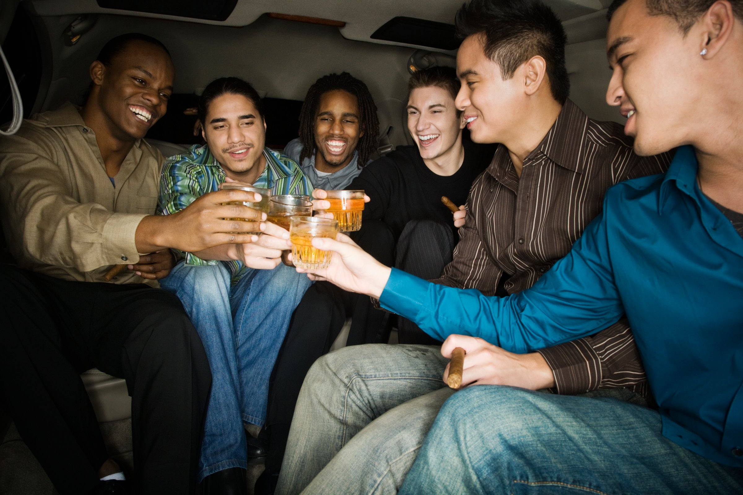 Multi-ethnic men toasting with drinks