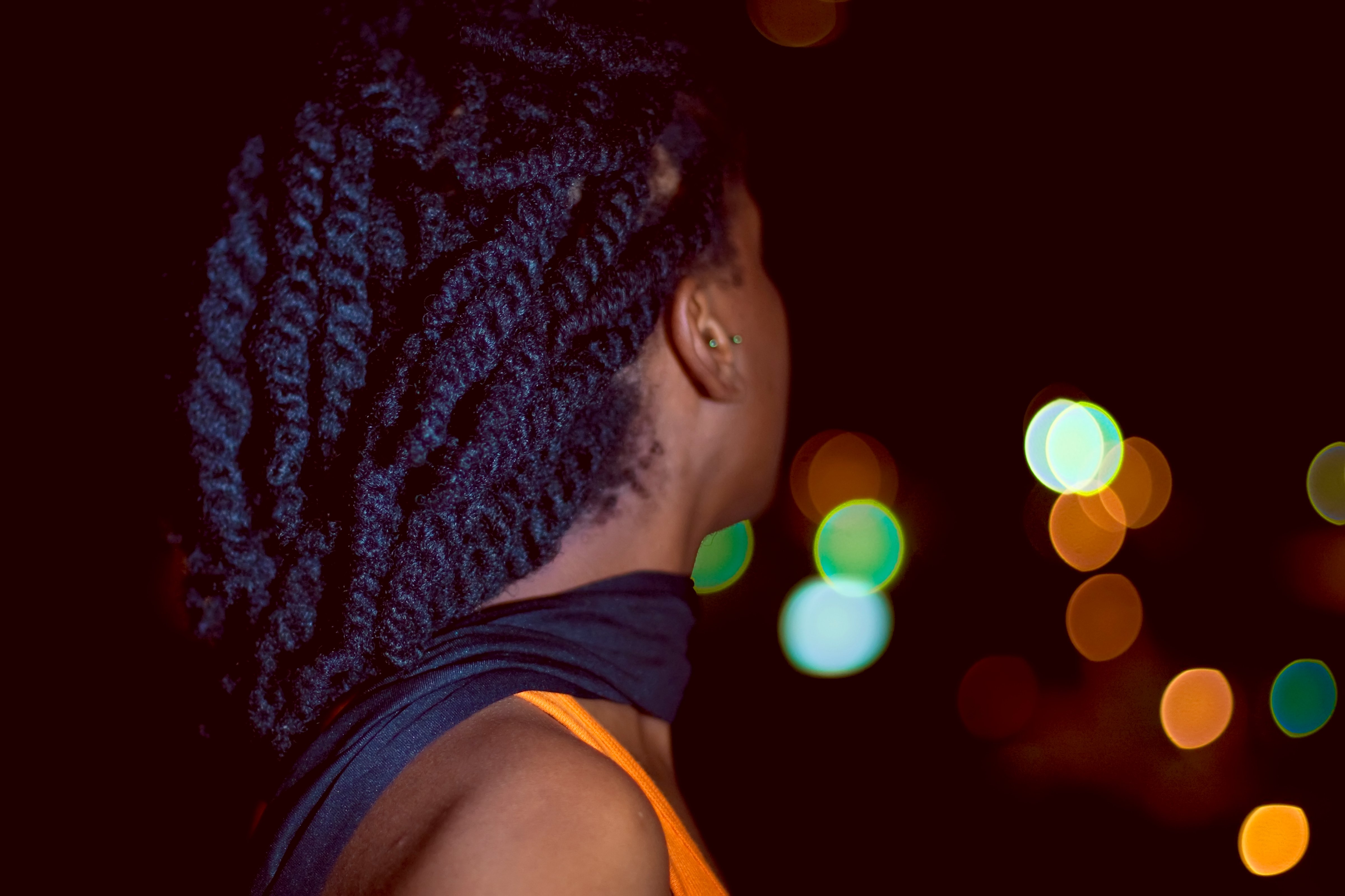 Black woman looking towards the city lights