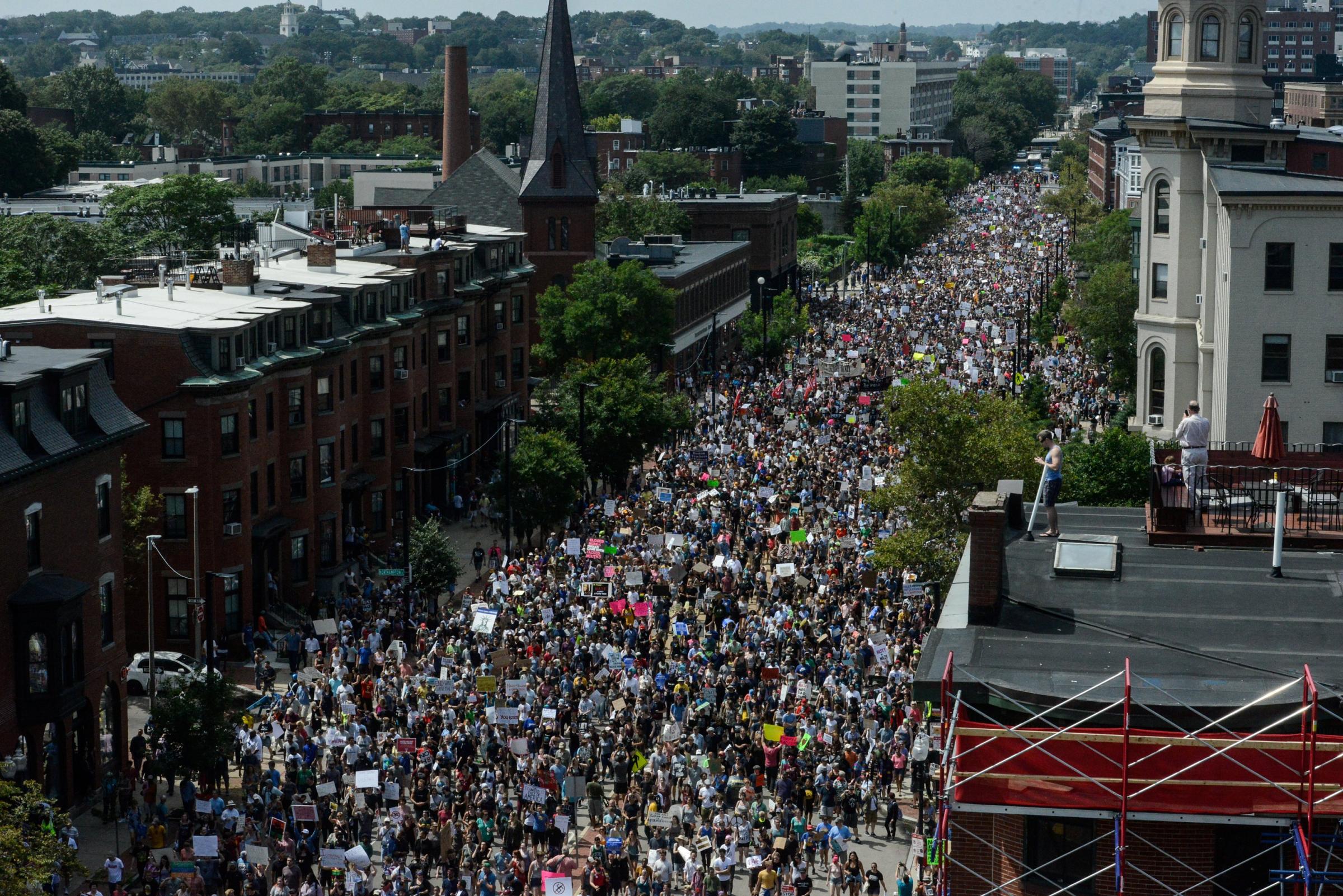 A large crowd of people march towards the Boston Commons to protest the Boston Free Speech Rally in Boston, MA