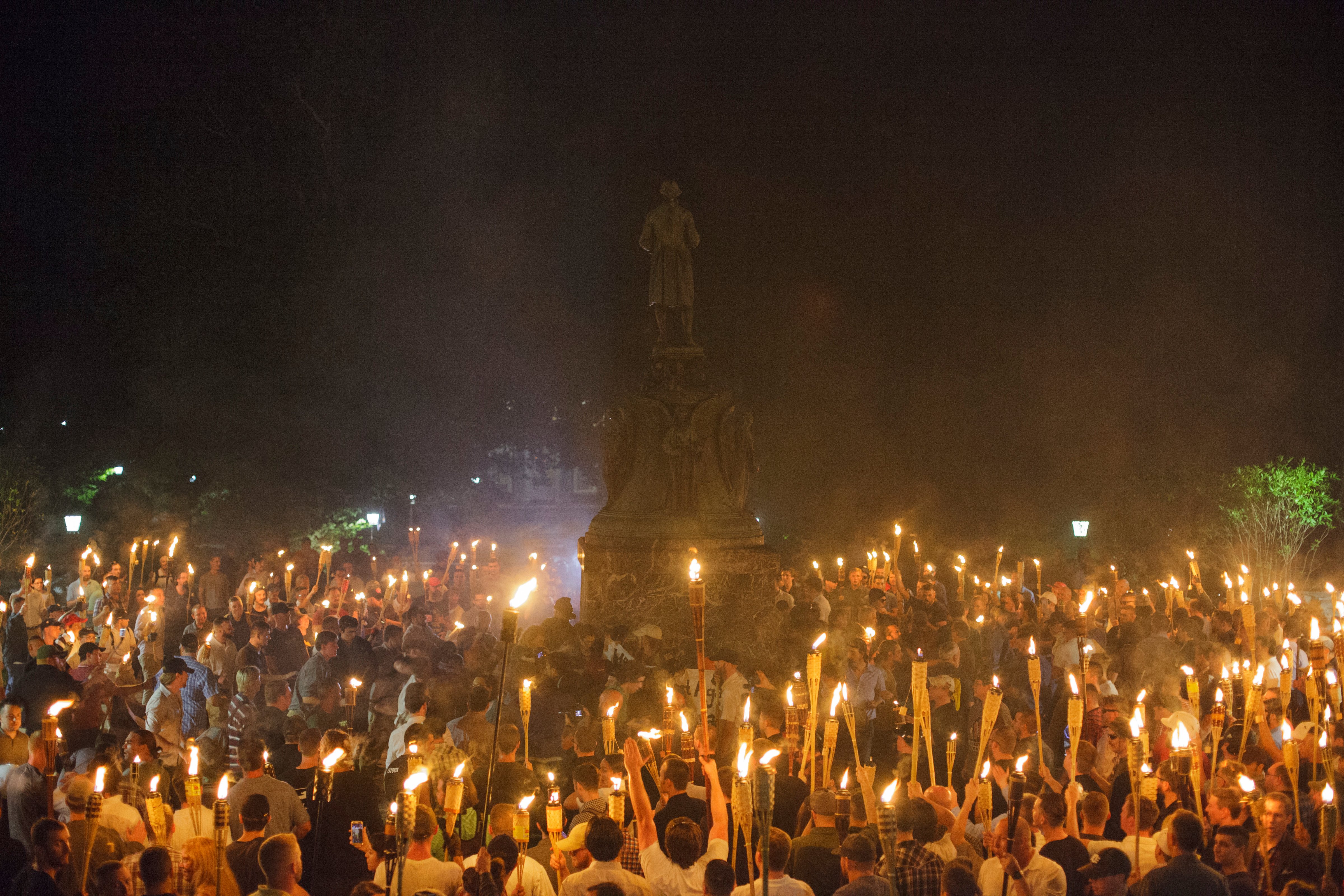 Neo Nazis, Alt-Right, and White Supremacists encircle counter protestors at the base of a statue of Thomas Jefferson after marching through the University of Virginia campus with torches in Charlottesville, Va. on August 11, 2017. (Shay Horse&mdash;Sipa USA/AP)