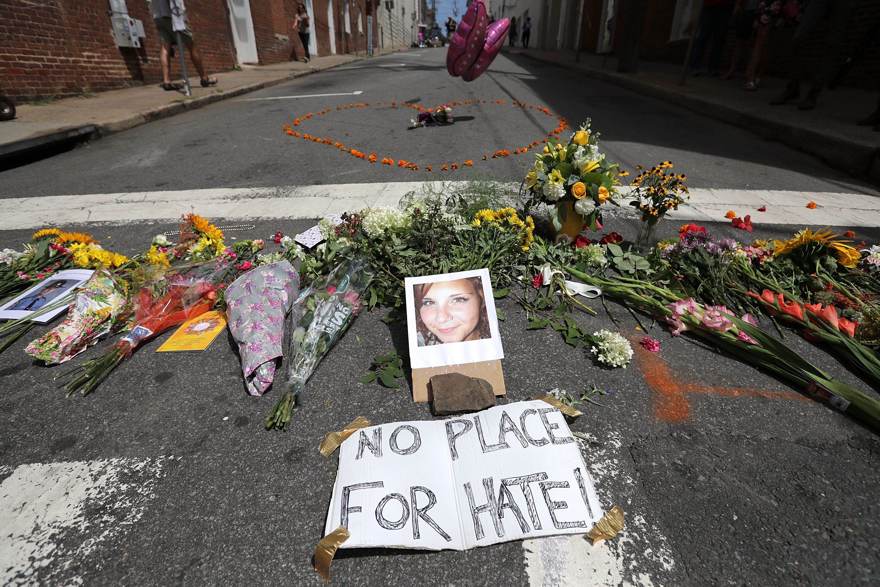 Flowers surround a photo of 32-year-old Heather Heyer, who was killed when a car plowed into a crowd of people protesting against the white supremacist Unite the Right rally, August 13, 2017 in Charlottesville, Va. (Chip Somodevilla&mdash;Getty Images)