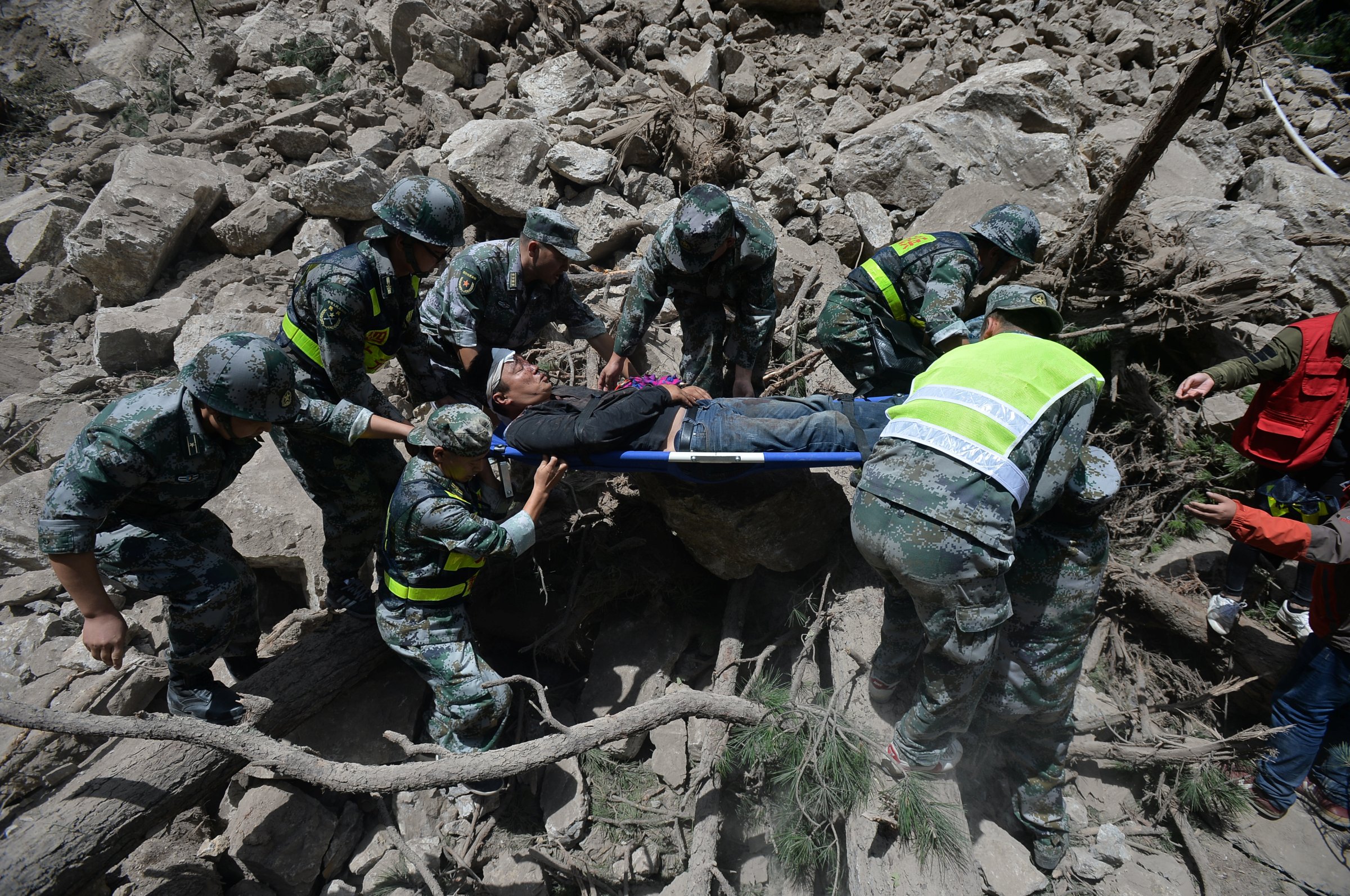 Chinese paramilitary police carry a survivor after an earthquake in Jiuzhaigou county