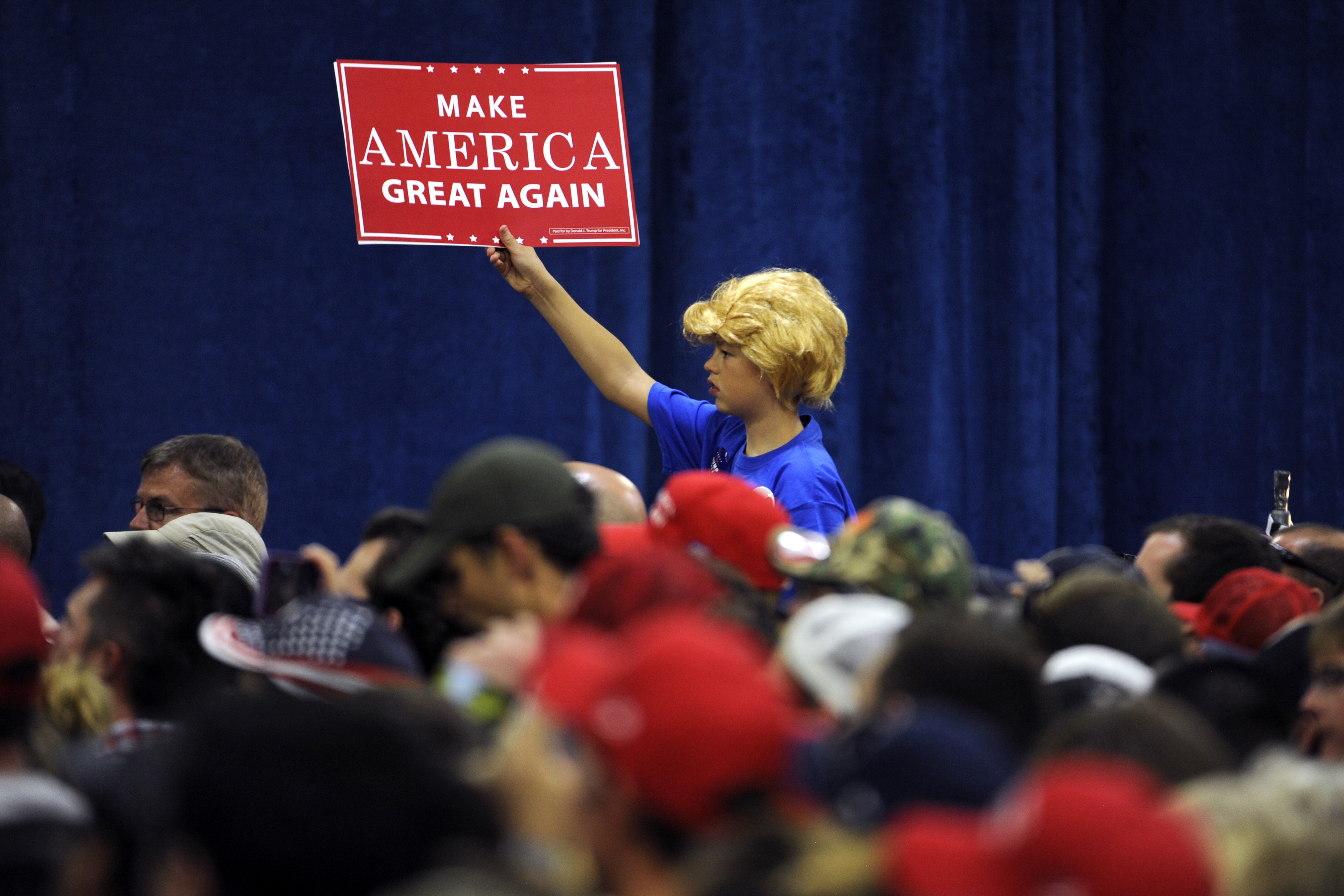 A young boy wearing a Donald Trump wig holds up a campaign sign during Republican presidential nominee Donald Trump's campaign rally at the Bank of Colorado Arena on the campus of University of Northern Colorado in Greeley, Colorado on October 30, 2016. (Jason Connolly&mdash;AFP/Getty Images)