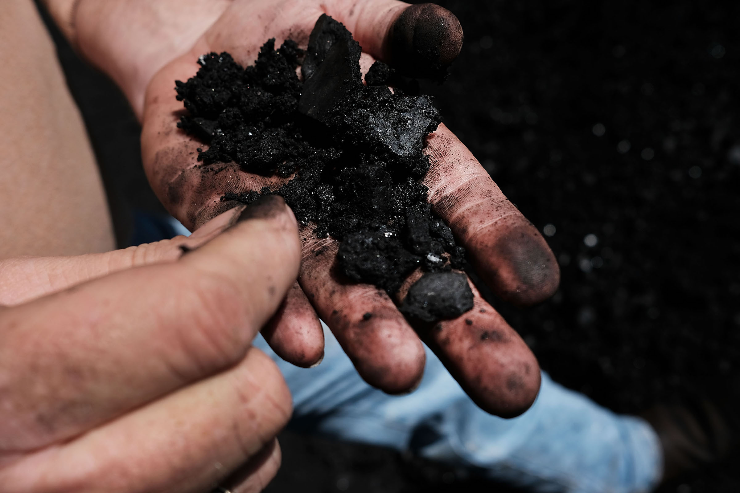 A worker in the coal industry handles coal at a coal prep plant on May 19, 2017 outside the city of Welch, West Virginia. (Spencer Platt&mdash;Getty Images)