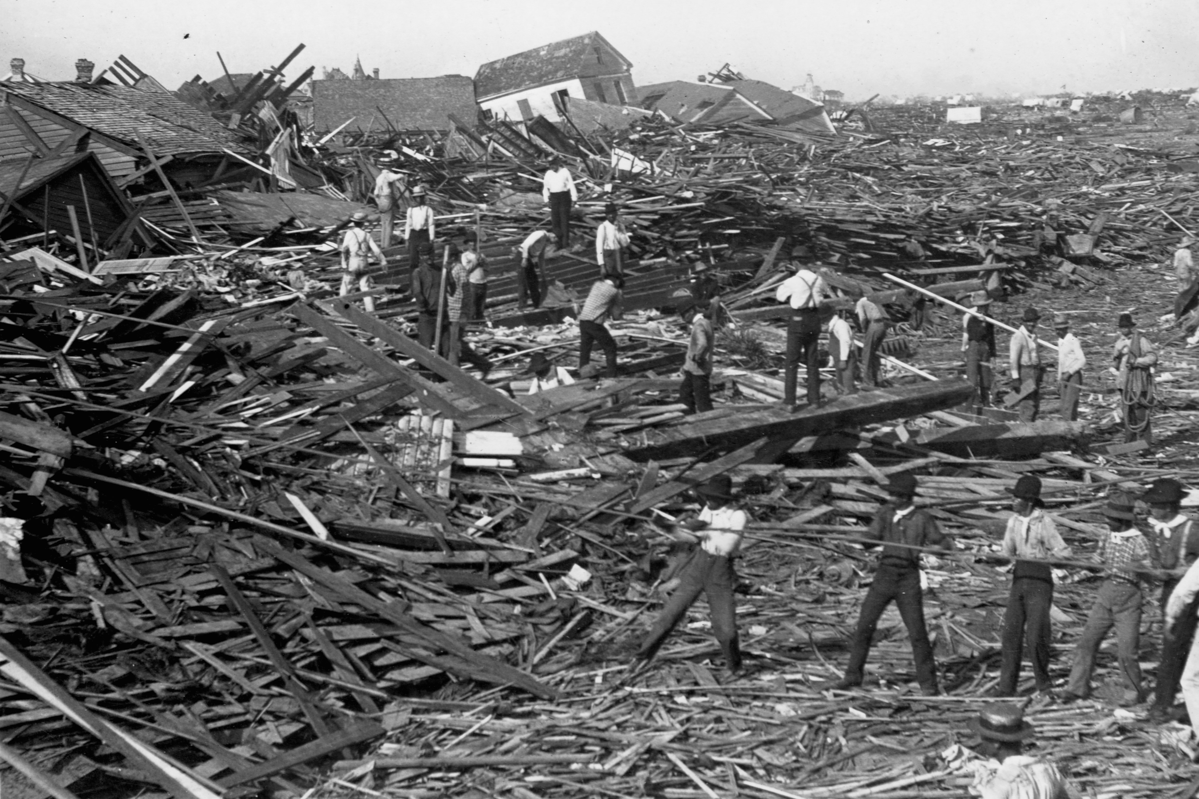 Men use ropes to pull away the debris of houses in order to look for bodies, after the Galveston Hurricane of 1900. (Library of Congress/Corbis/VCG—Getty Images)