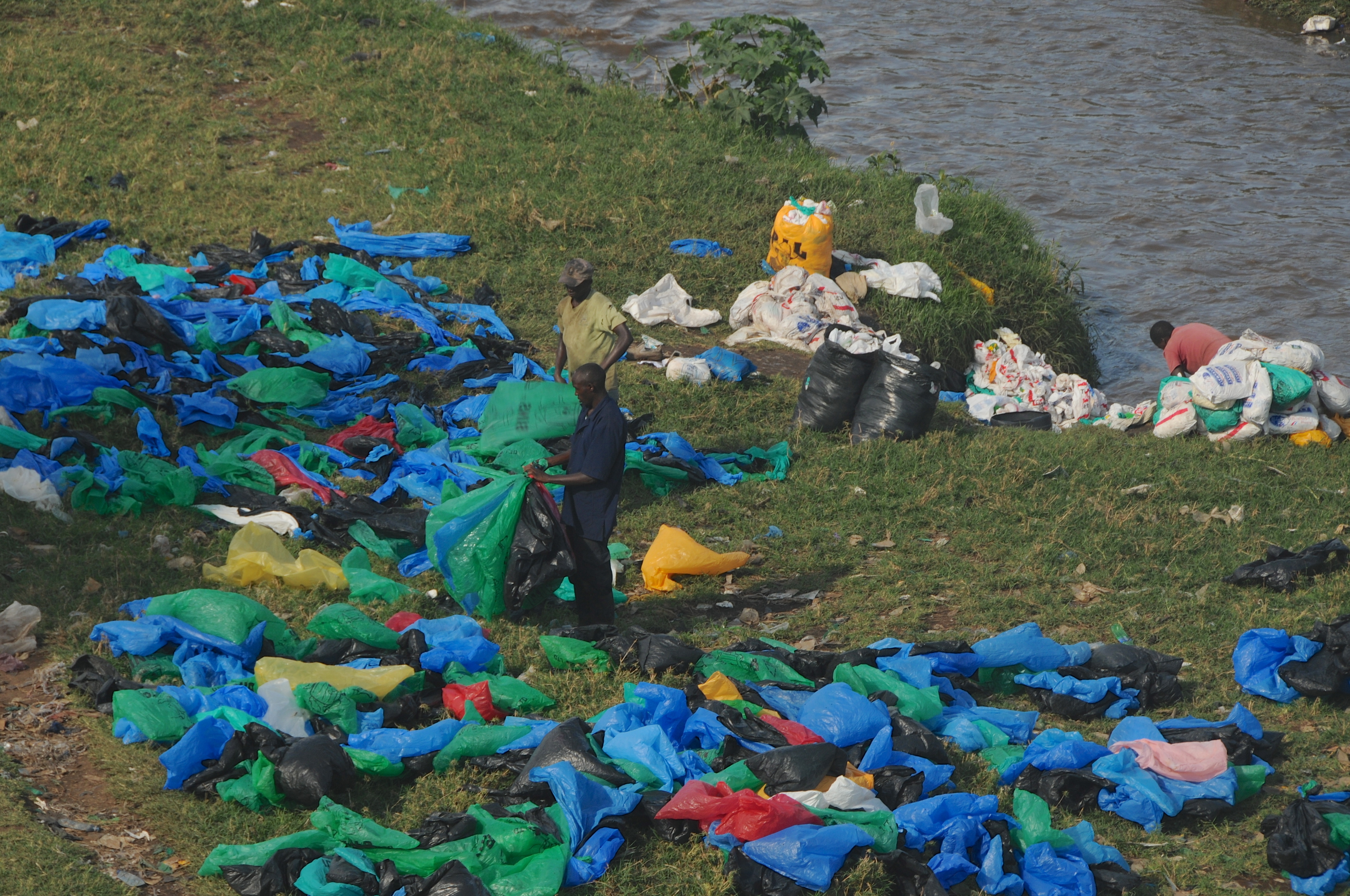 This undated photo shows Kenyans collecting used plastic bags from Nairobi River to resell in marketplaces near the Mukuru slum in Kenya. (Wendy Stone—Corbis/Getty Images)