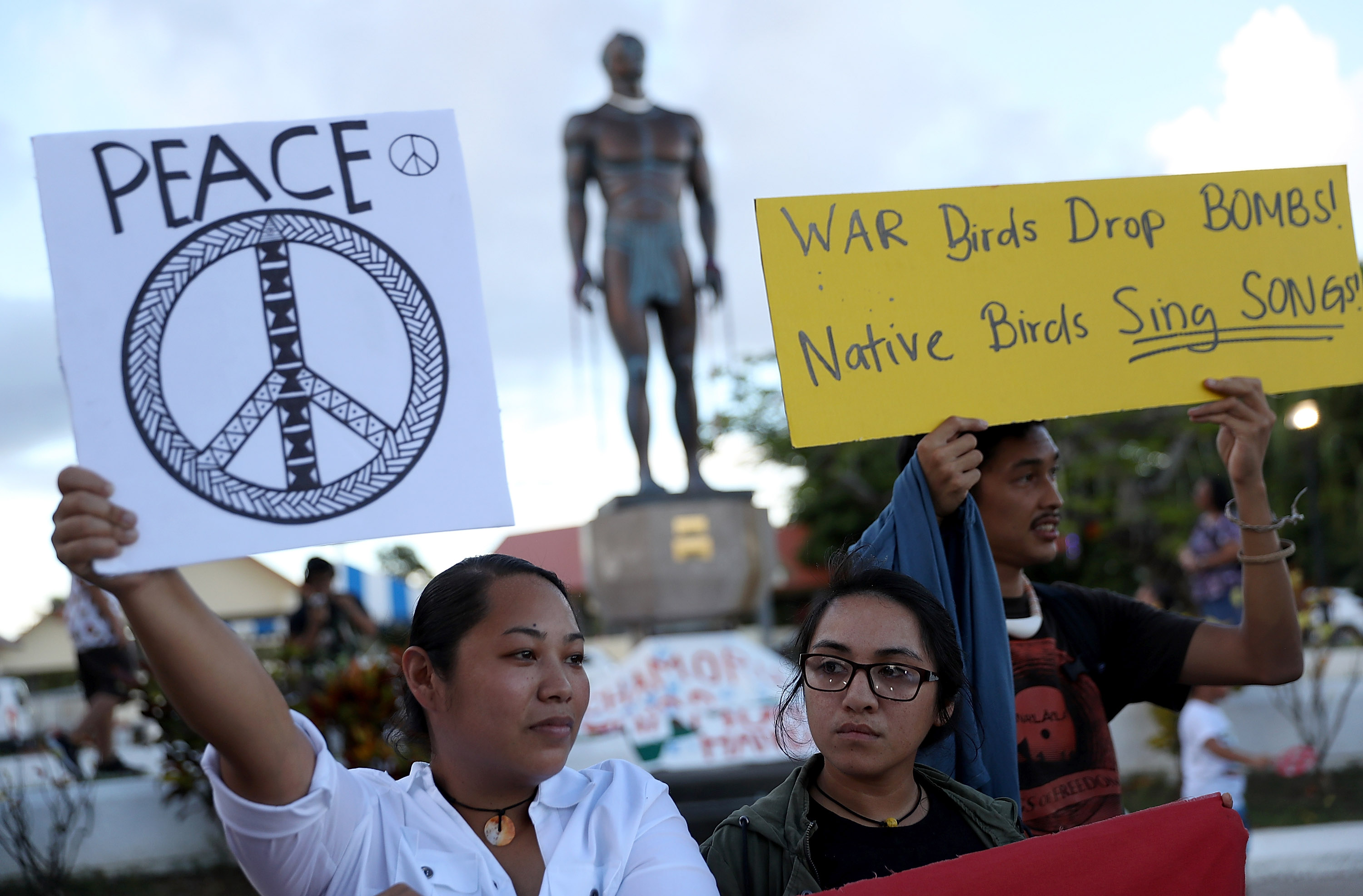 Protesters hold signs during a People for Peace Rally at the Chief Quipuha Statue on August 14, 2017 in Hagatna, Guam. (Justin Sullivan—Getty Images)