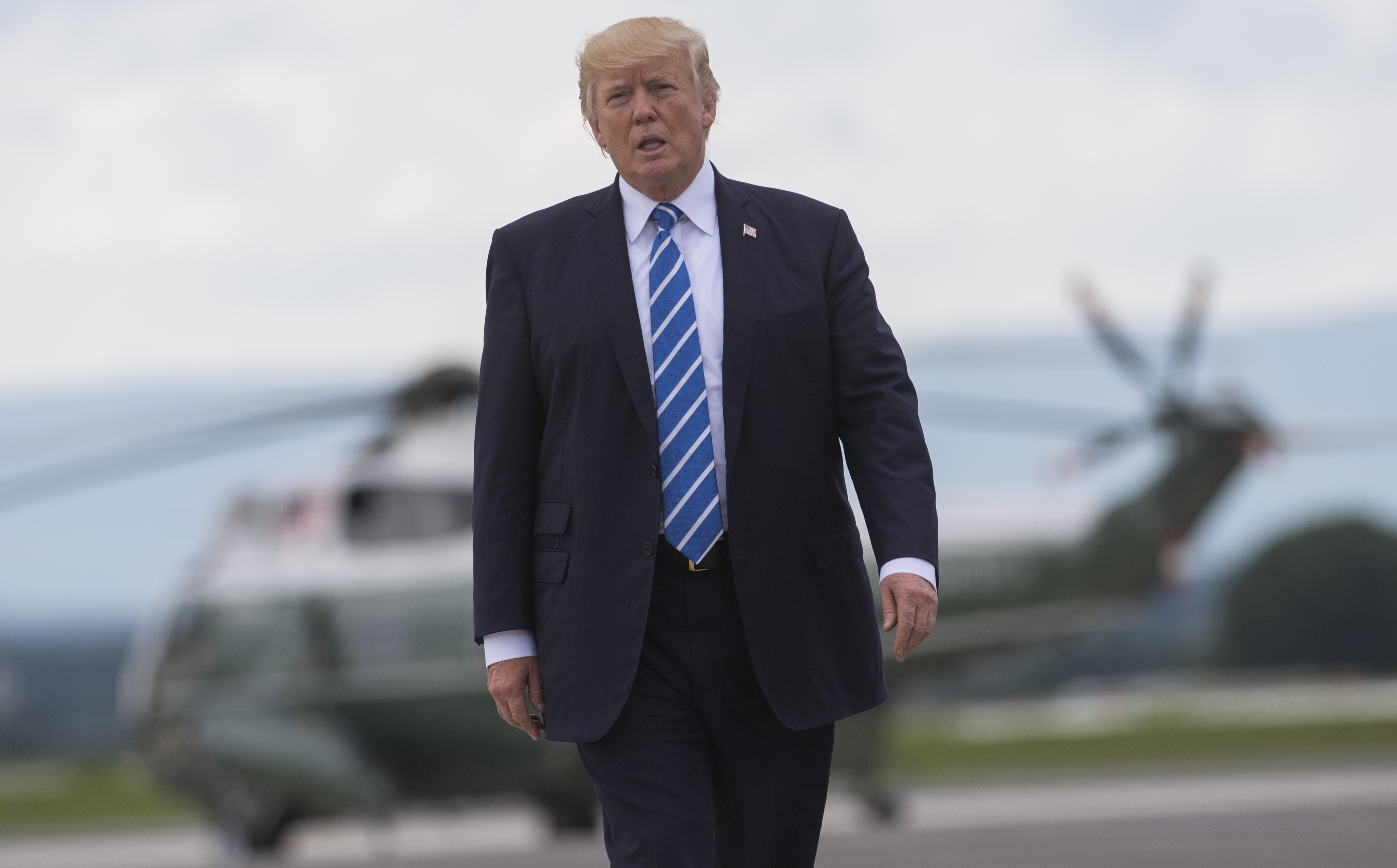 US President Donald Trump walks from Marine One to board Air Force One prior to departing from Hagerstown Regional Airport in Hagerstown, Maryland, on August 18, 2017, following meetings at Camp David and before returning to Bedminster, New Jersey to continue his vacation. (Saul Loeb&mdash;AFP/Getty Images)